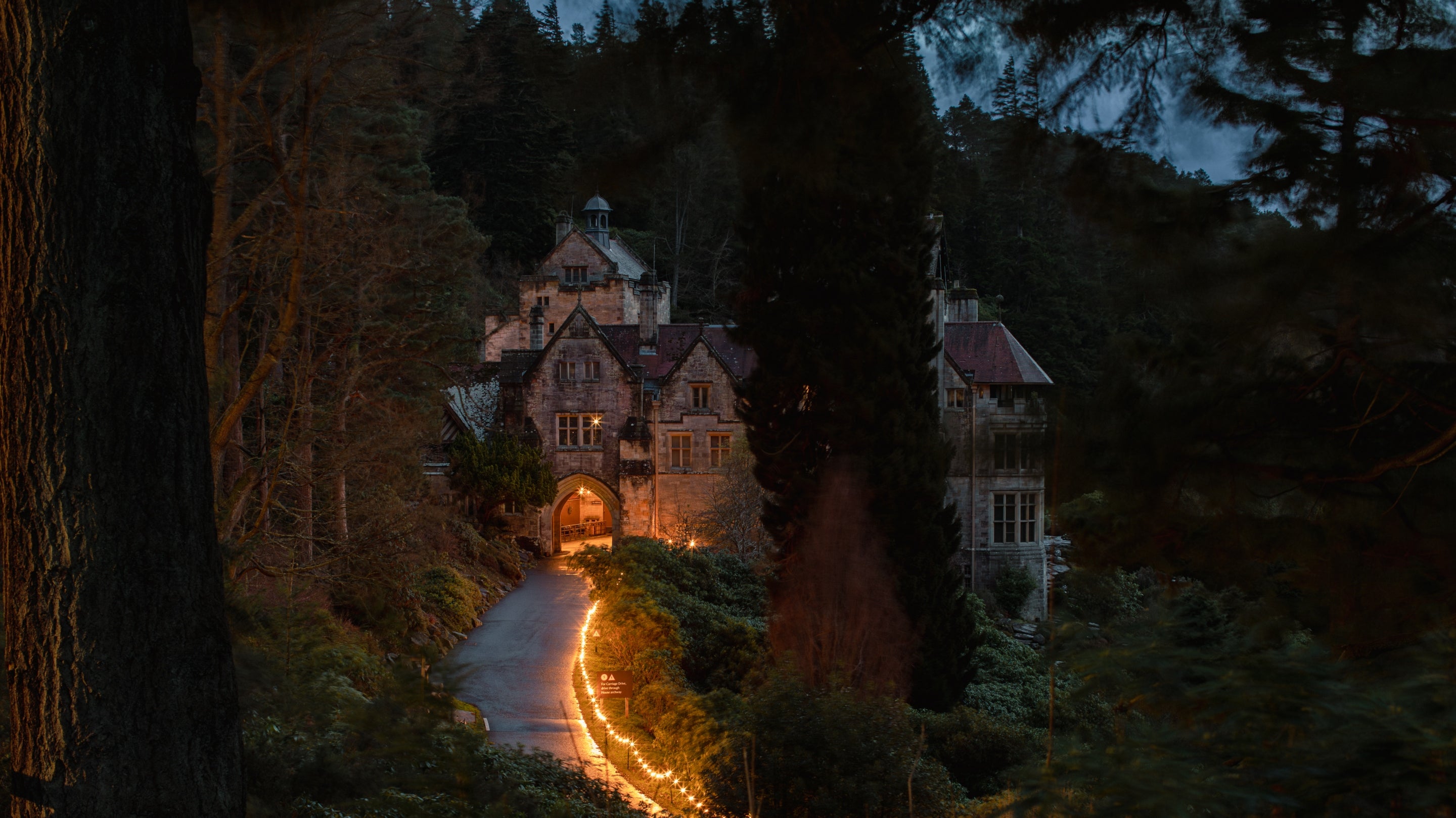 The drive leading to Cragside House illuminated with Christmas fairy lights