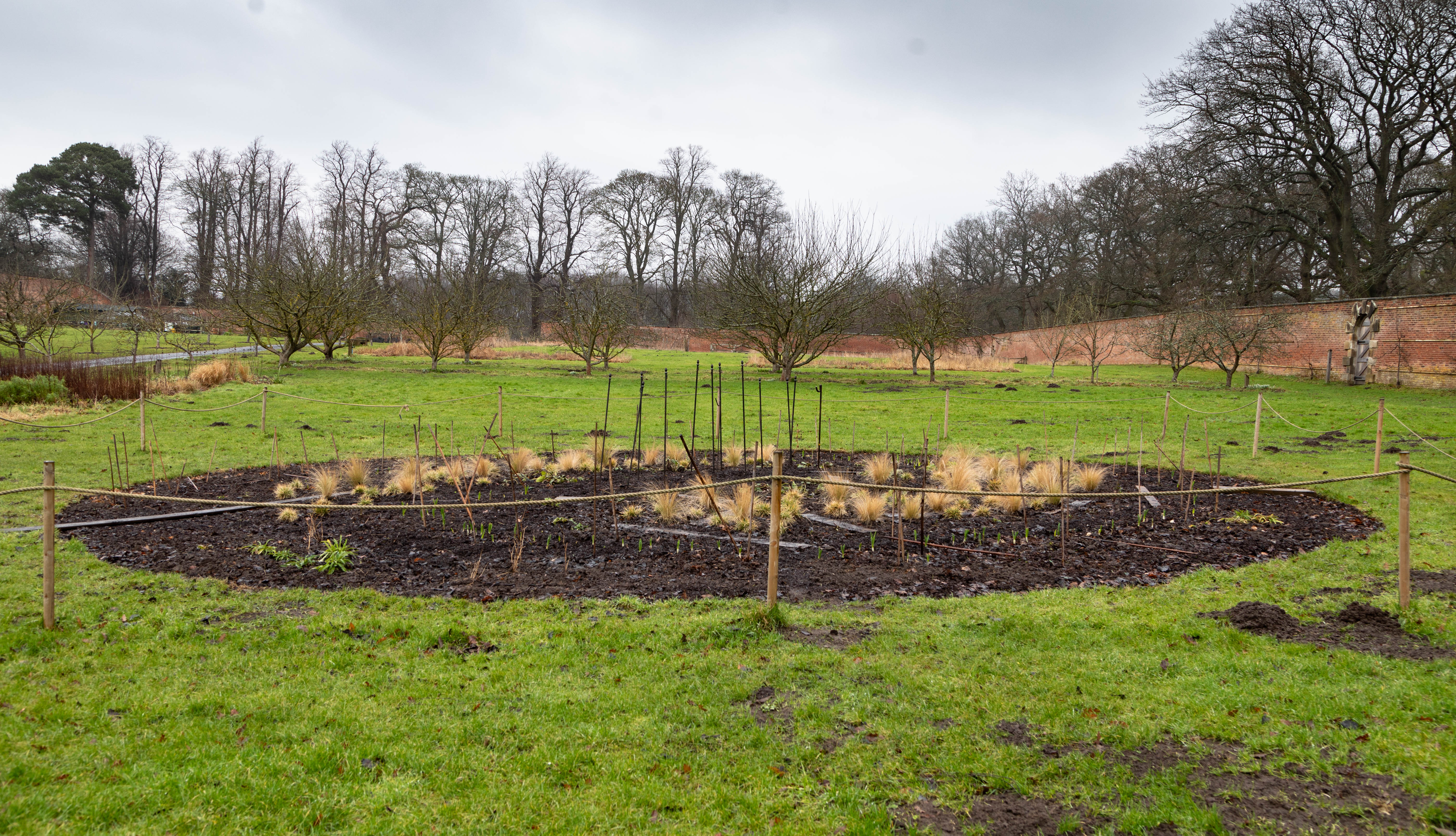 The Walled Garden galaxy shaped flower bed in March 2025