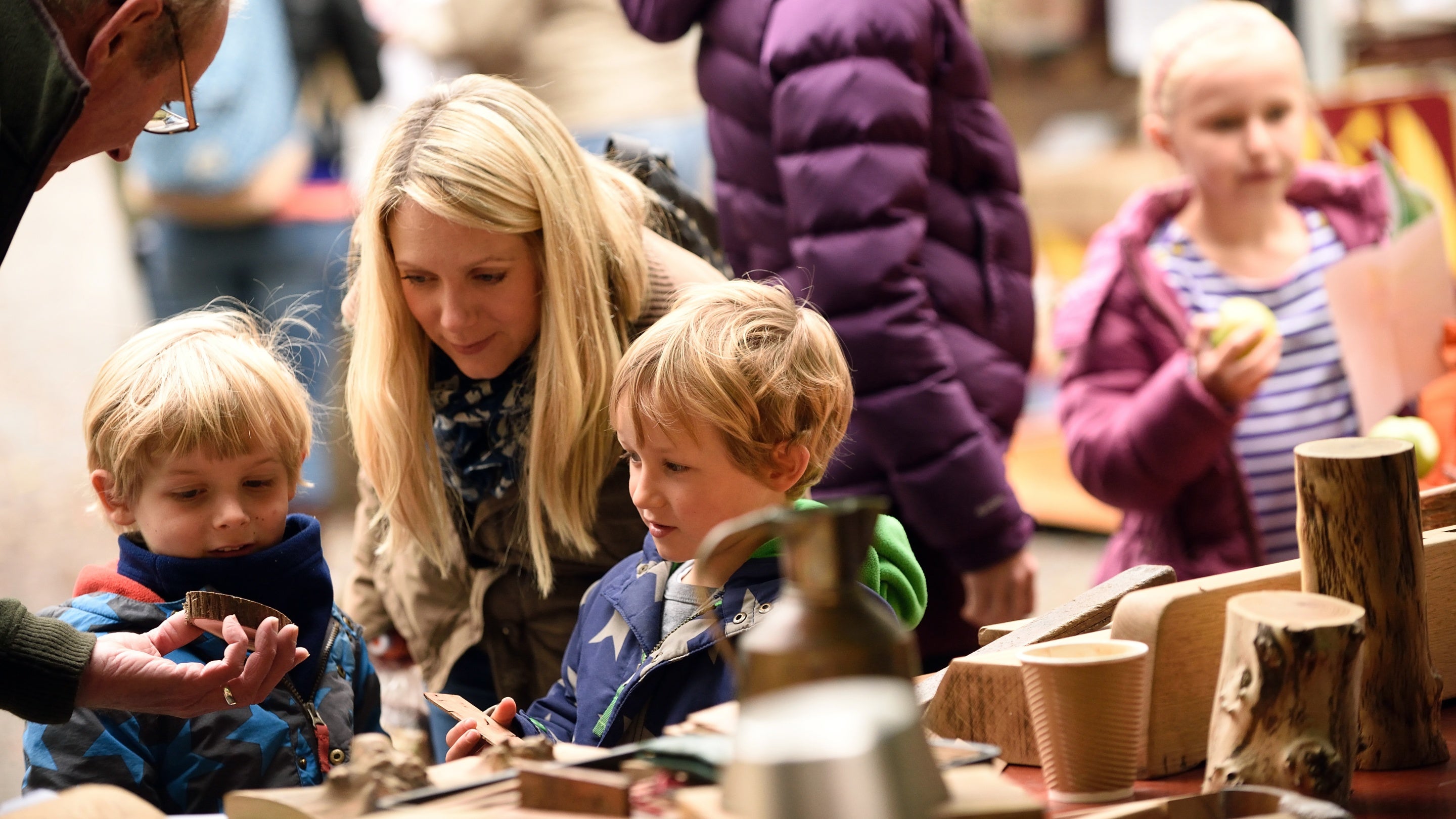 A family looking at some items on a craft stall