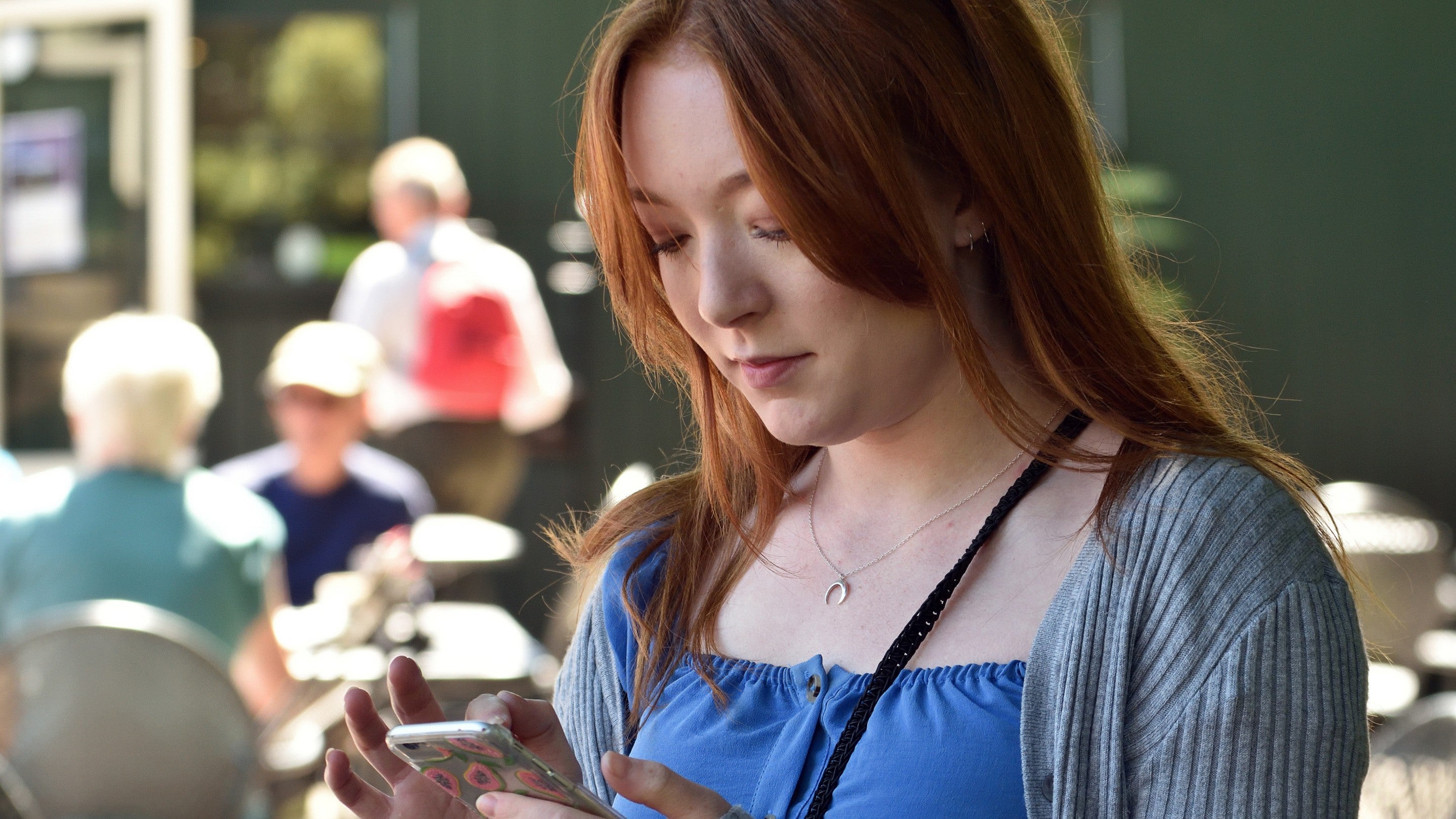Visitor looking at her phone at Gibside, Tyne & Wear