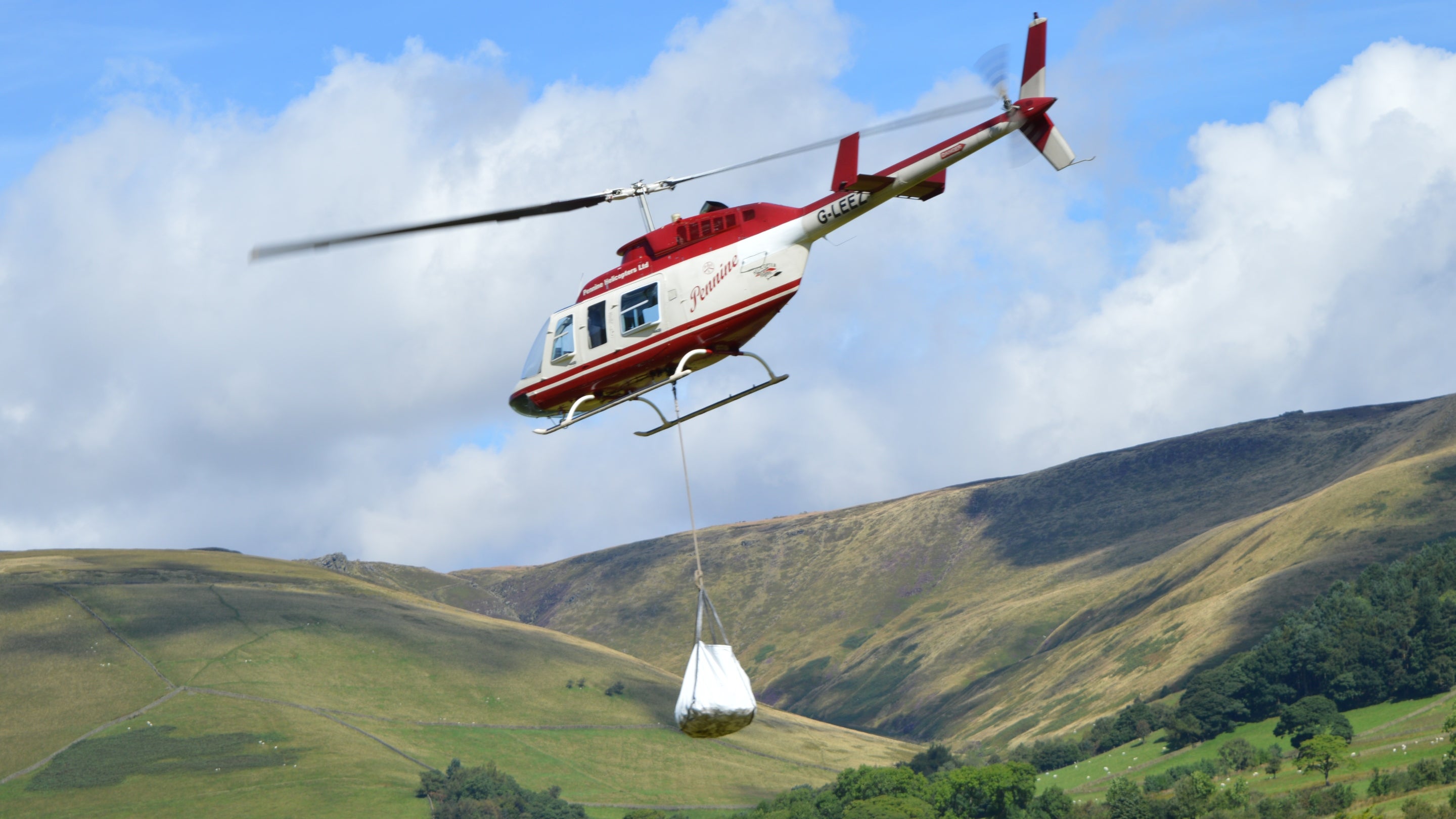 Helicopter helping with path repairs at High Peak Estate, Derbyshire