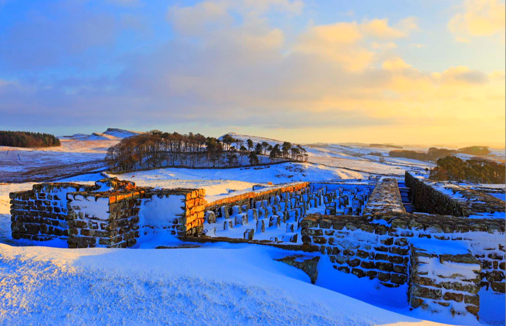 Housesteads Fort under a winter sky and a blanket of snow