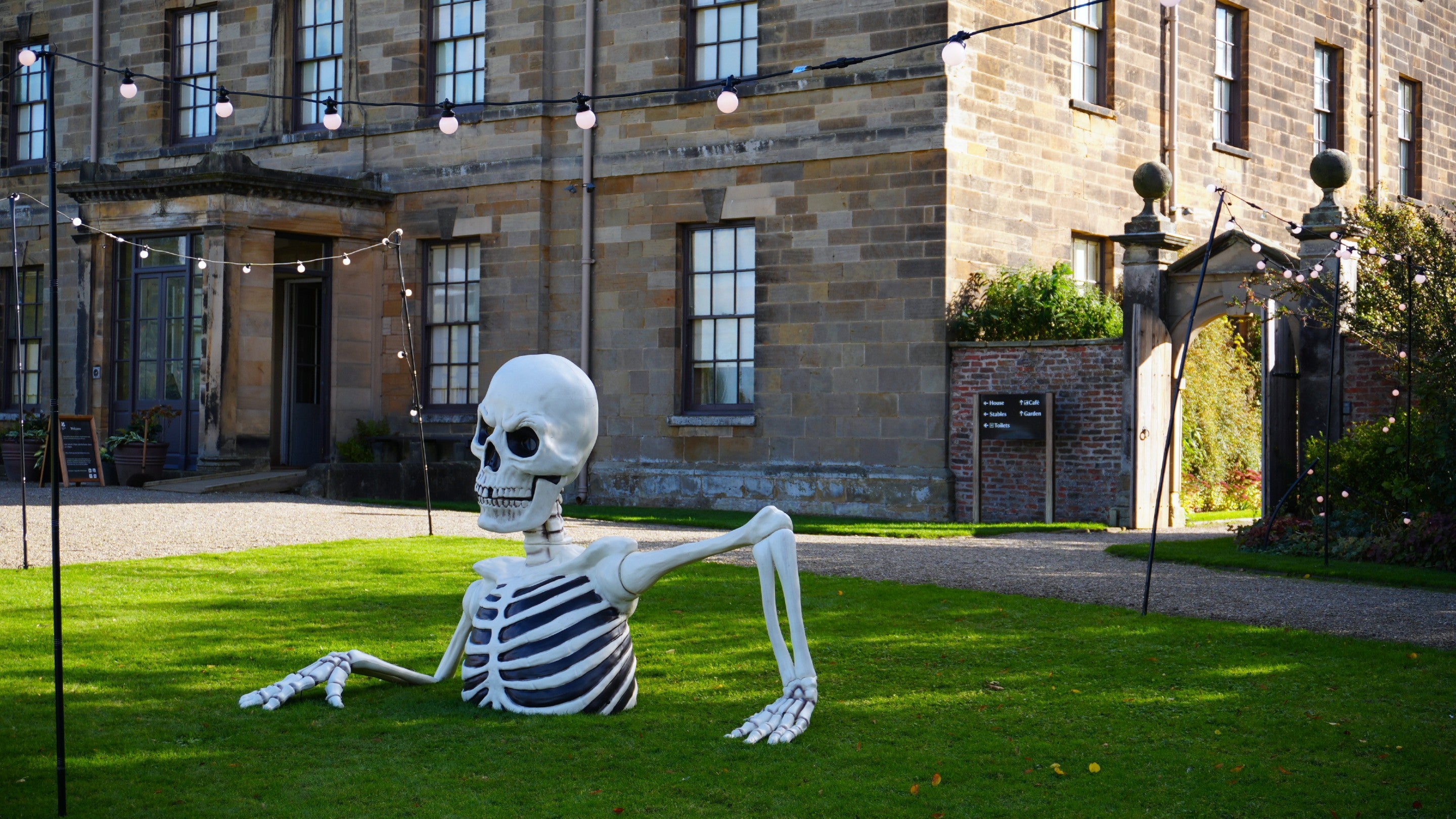 The head, arms and torso of a huge skeleton sits on the lawn out the front of Ormesby Hall