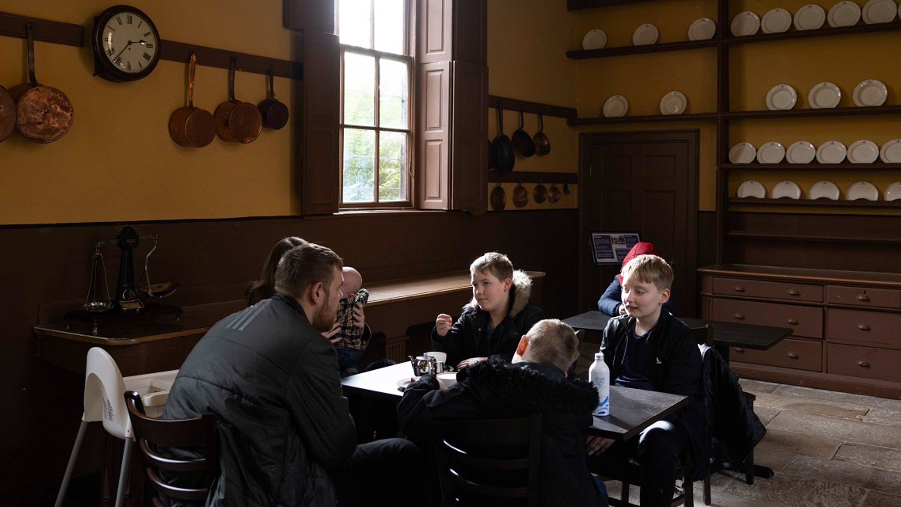 Family enjoying tearoom seating in the Victorian kitchen at Ormesby Hall