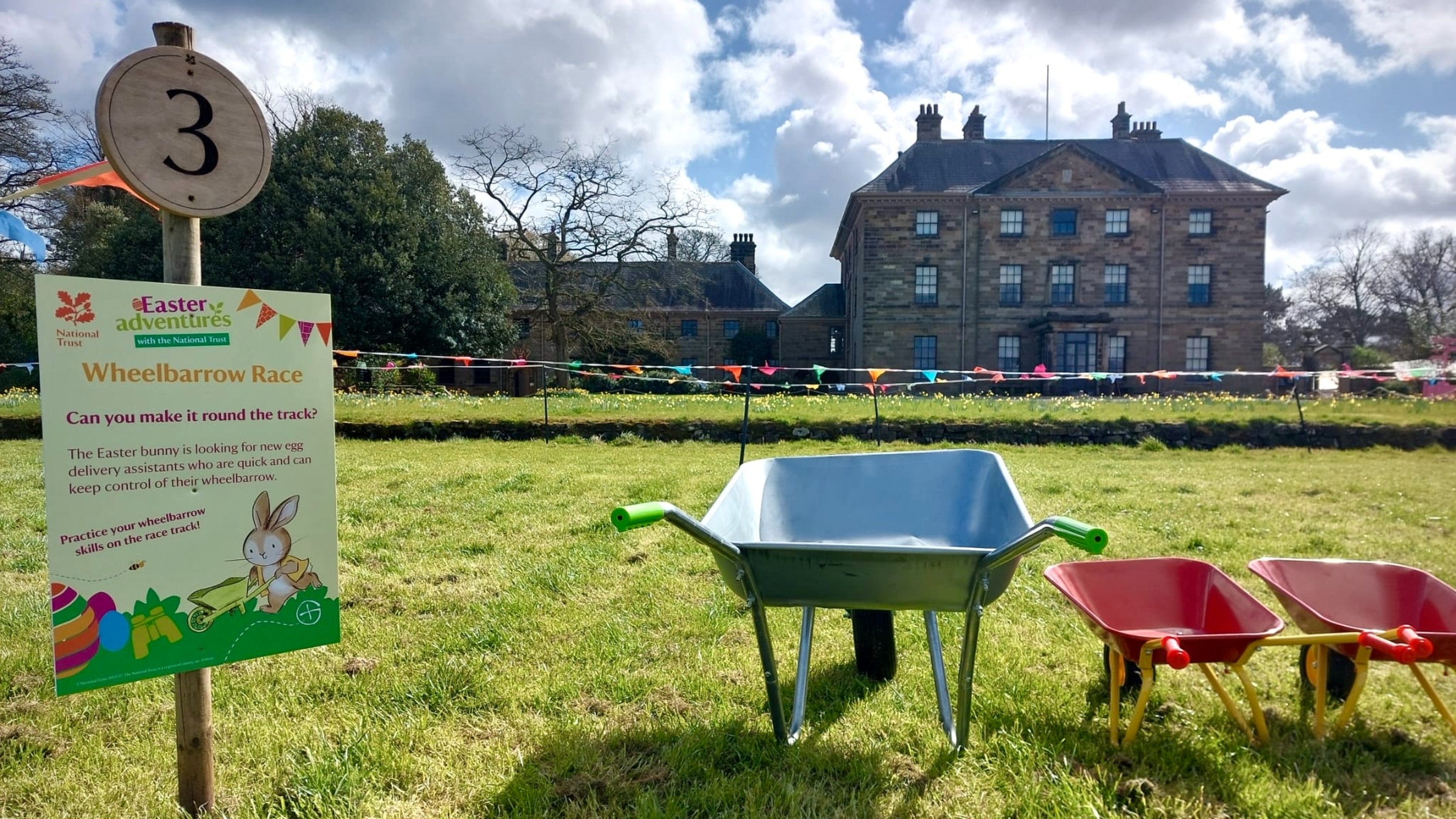 Wheelbarrows set up outside Ormesby Hall on front field ready for wheelbarrow racing