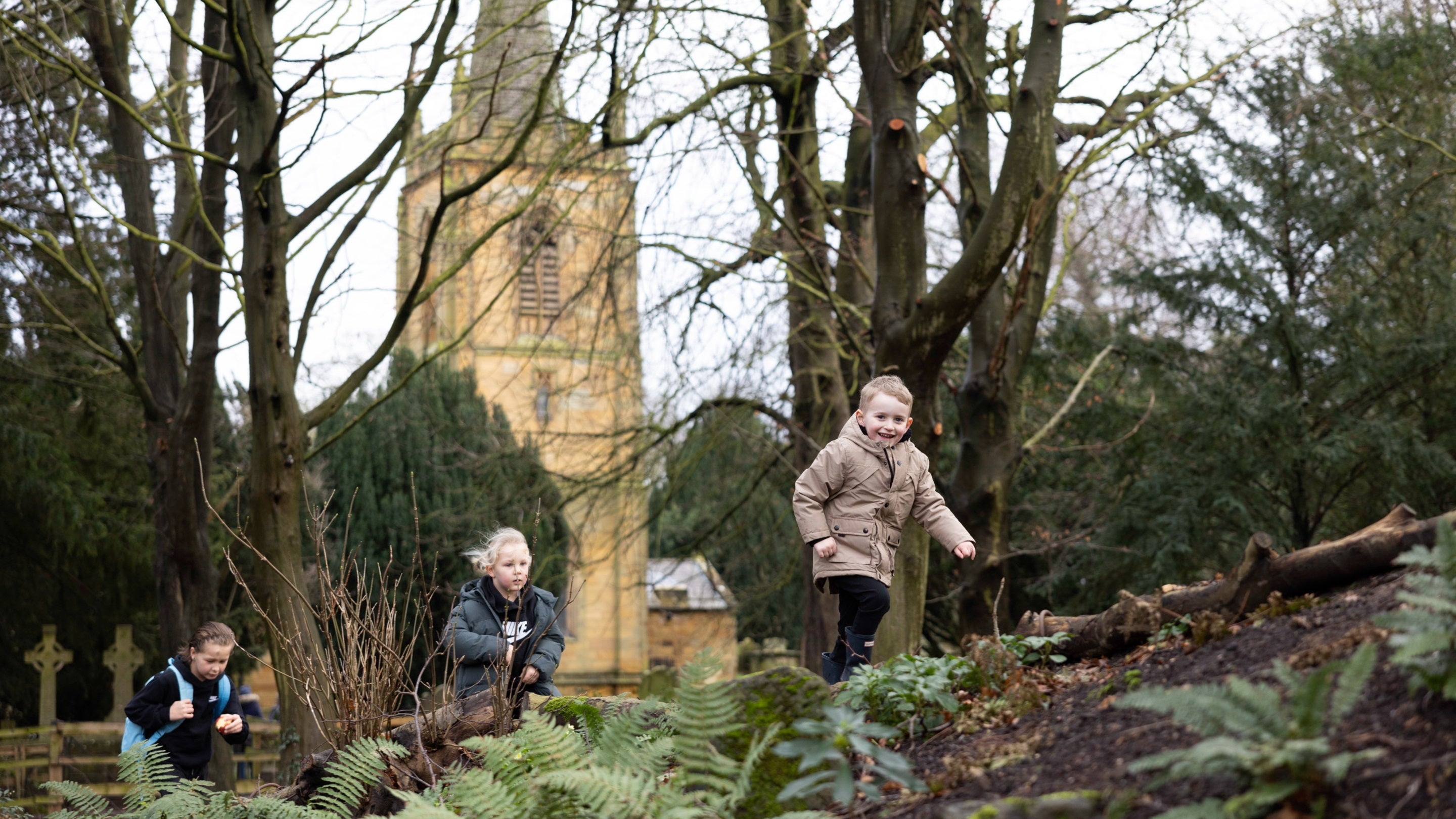 Young children enjoying the wooden garden at Ormesby Hall during winter
