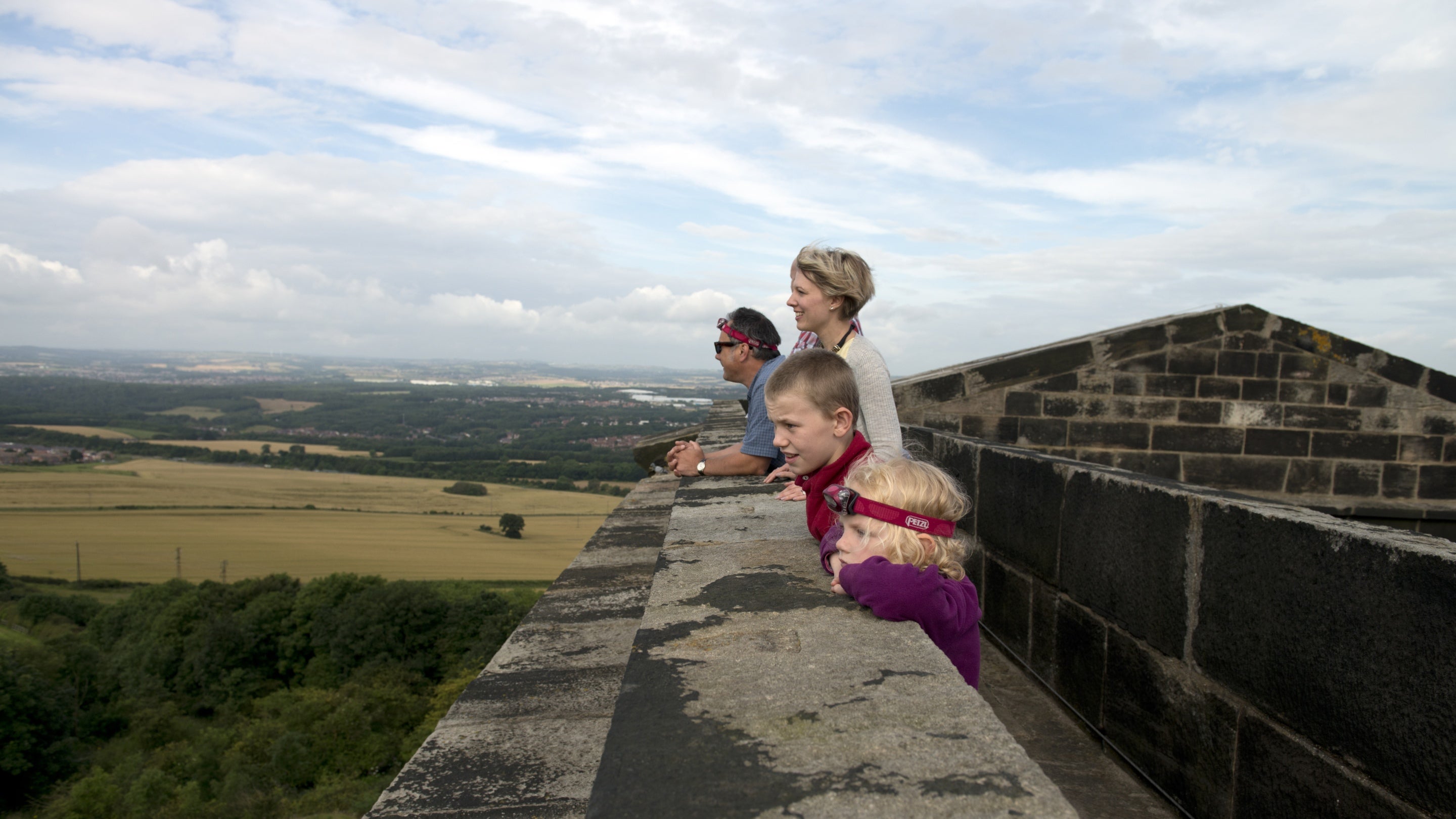 Two adults and two children look out at the view from Penshaw Monument, Sunderland