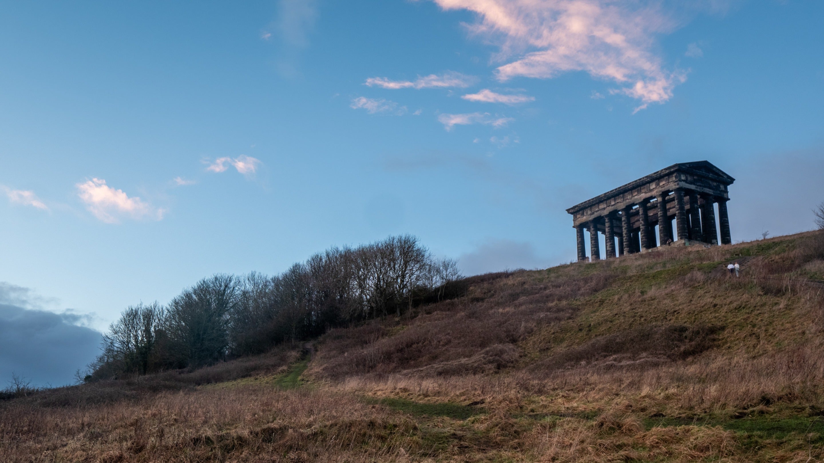 A classical ruin silhouetted against the sky
