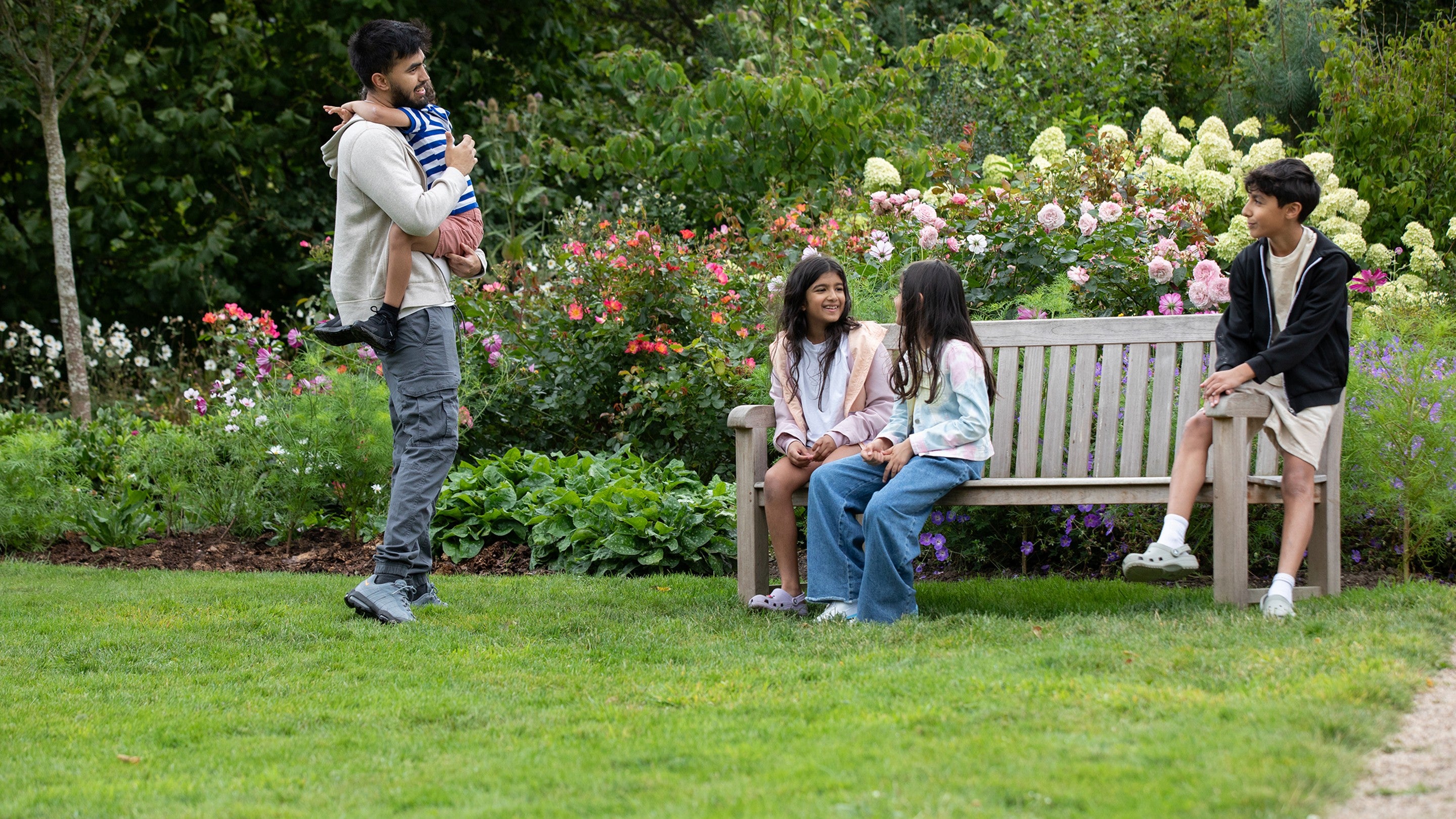 A family in the South East Gardens at Seaton Delaval Hall Northumberland in late summer