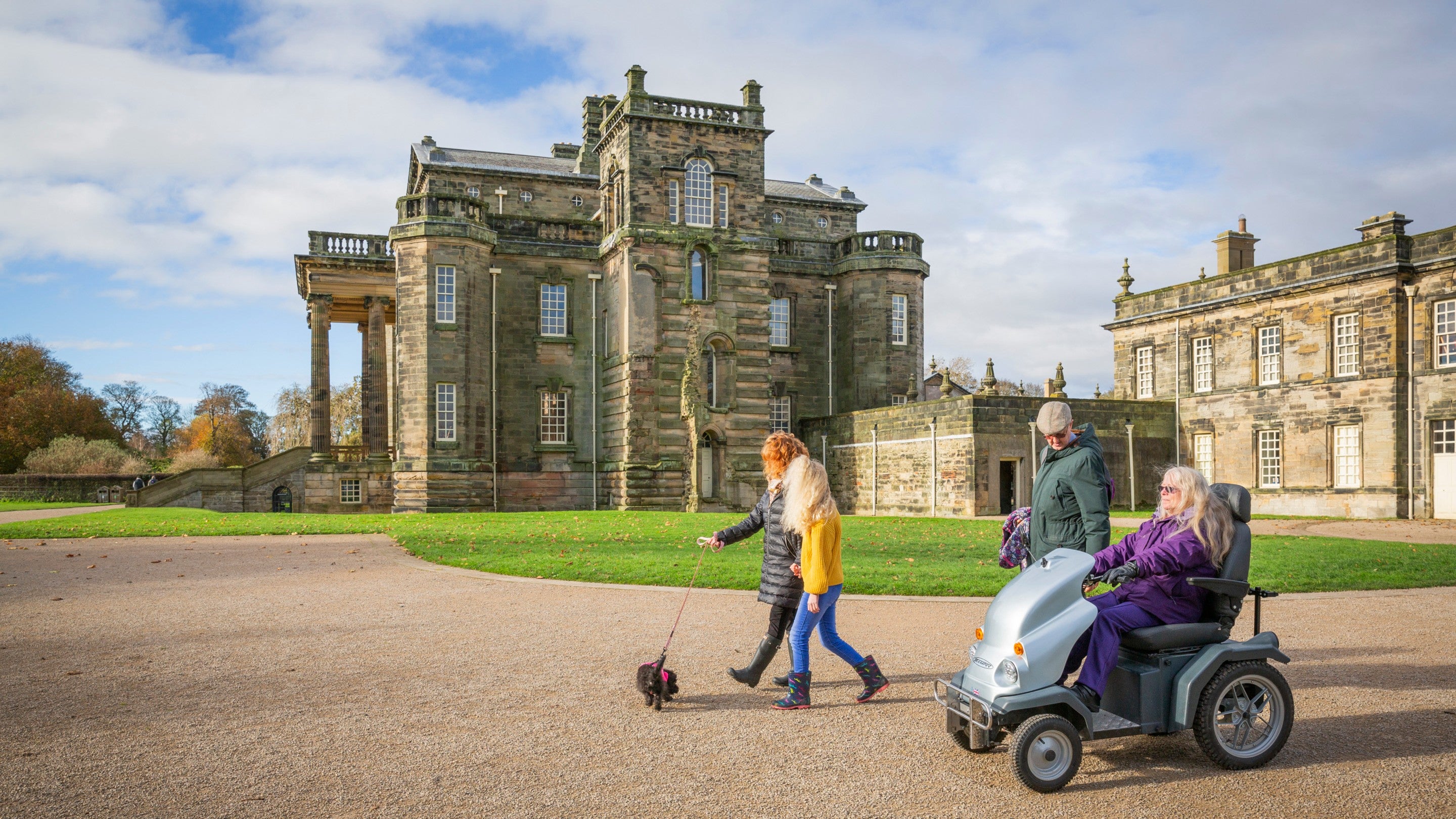 A family makes use of the free to hire all terrain mobility scooter at Seaton Delaval Hall Northumberland