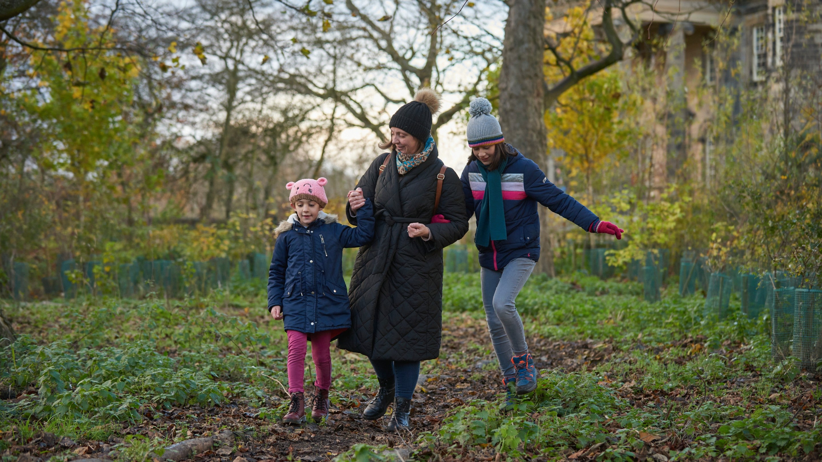 Family enjoying the Follow The Star Christmas trail in the garden at Seaton Delaval Hall, Northumberland