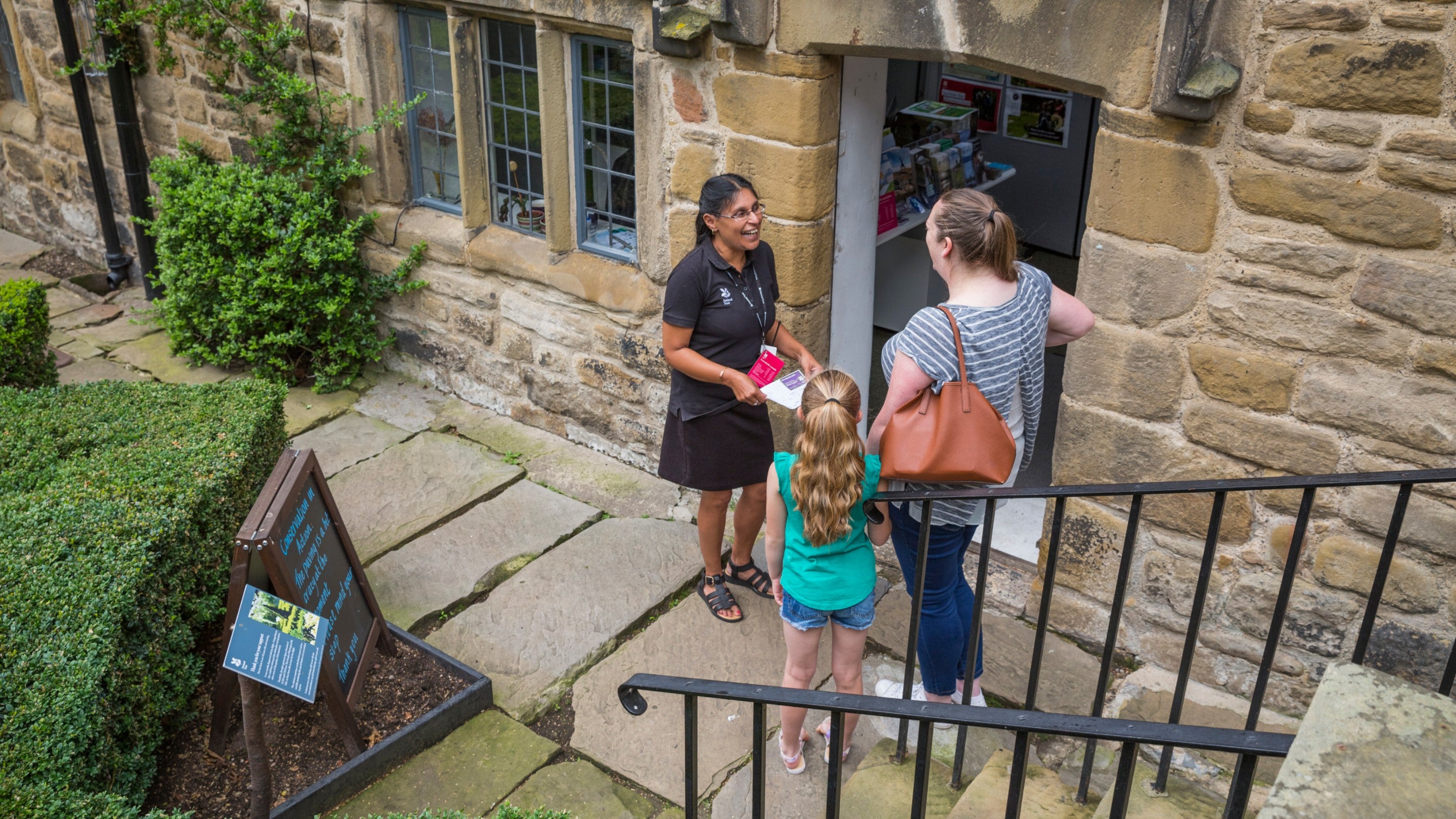 Staff and visitors in the garden at Washington Old Hall, Tyne & Wear