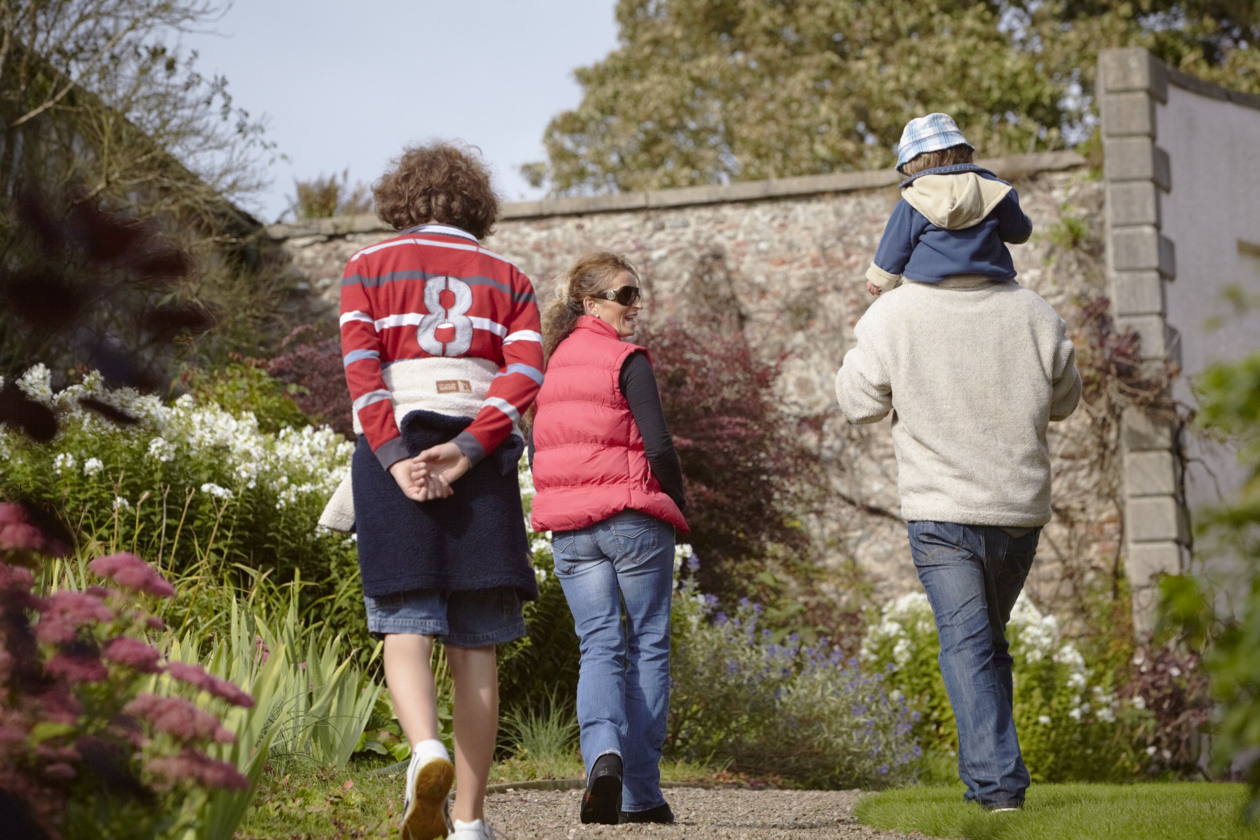 A family talk as they walk through the garden at Ardress House in County Armagh, Northern Ireland.