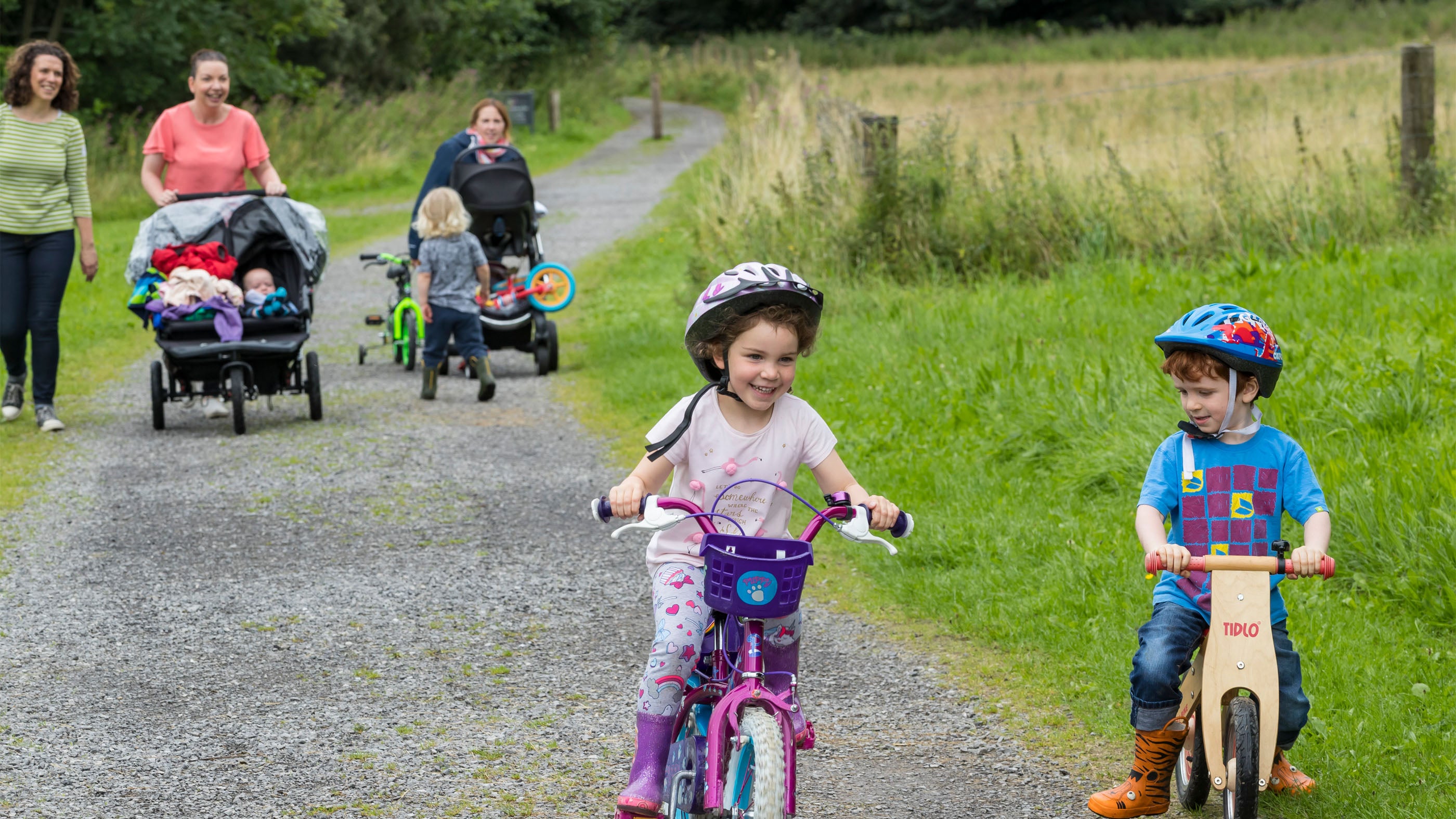 Children riding their bikes along a footpath at Castle Coole, County Fermanagh, Northern Ireland