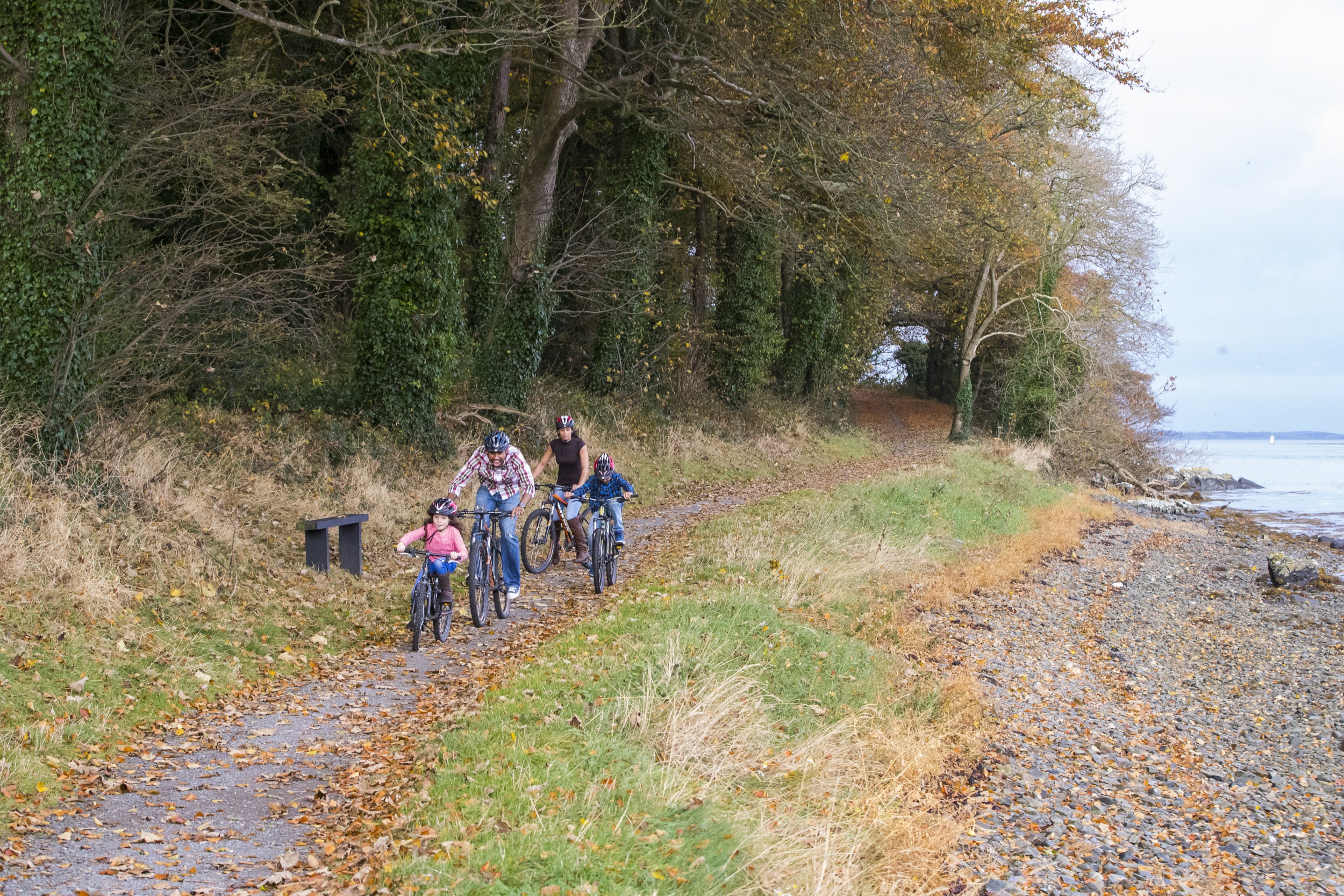 Family waling along the shore trail