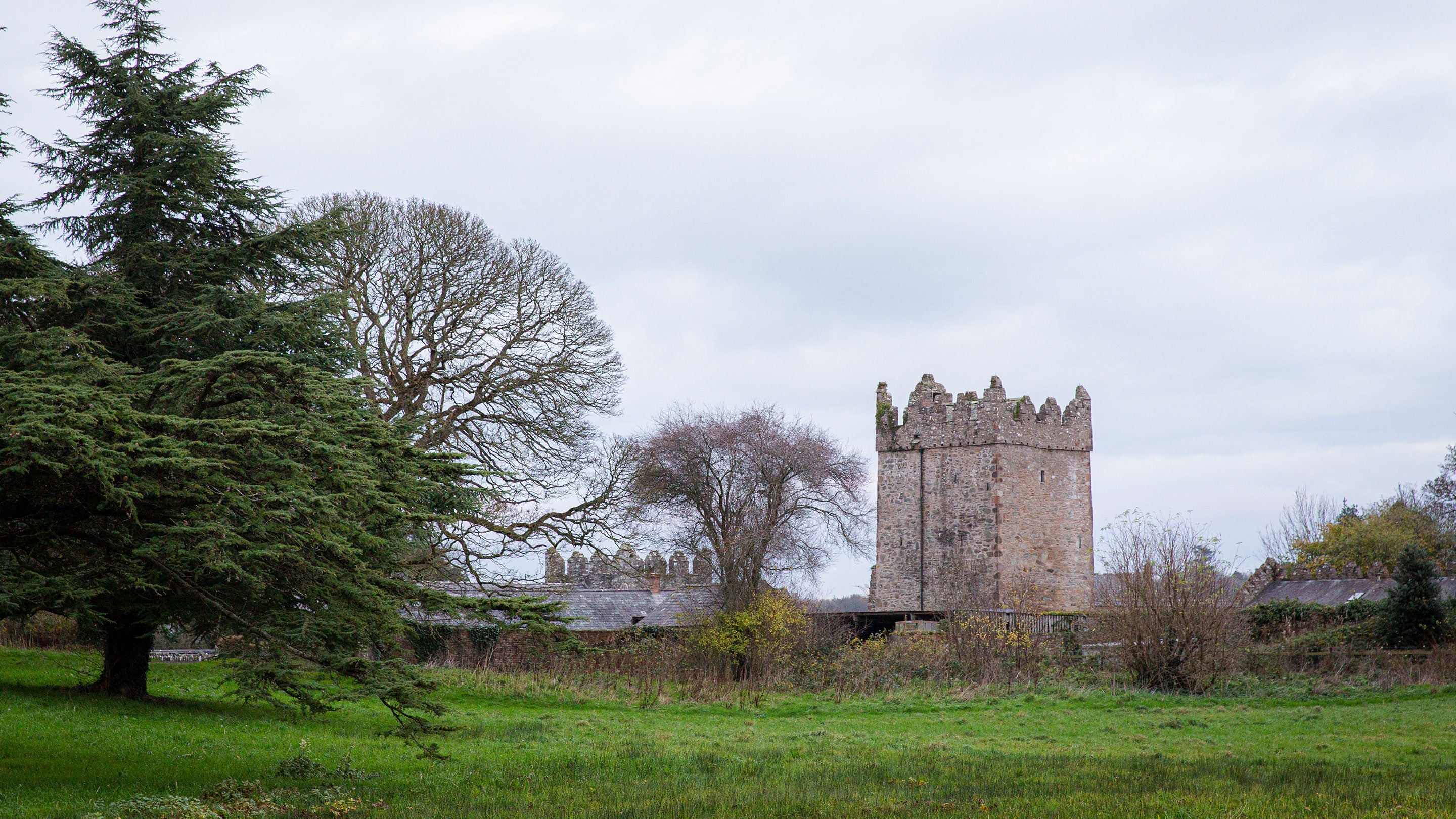 View of the wintery garden with the Clock Tower in the background at Castle Ward, County Down