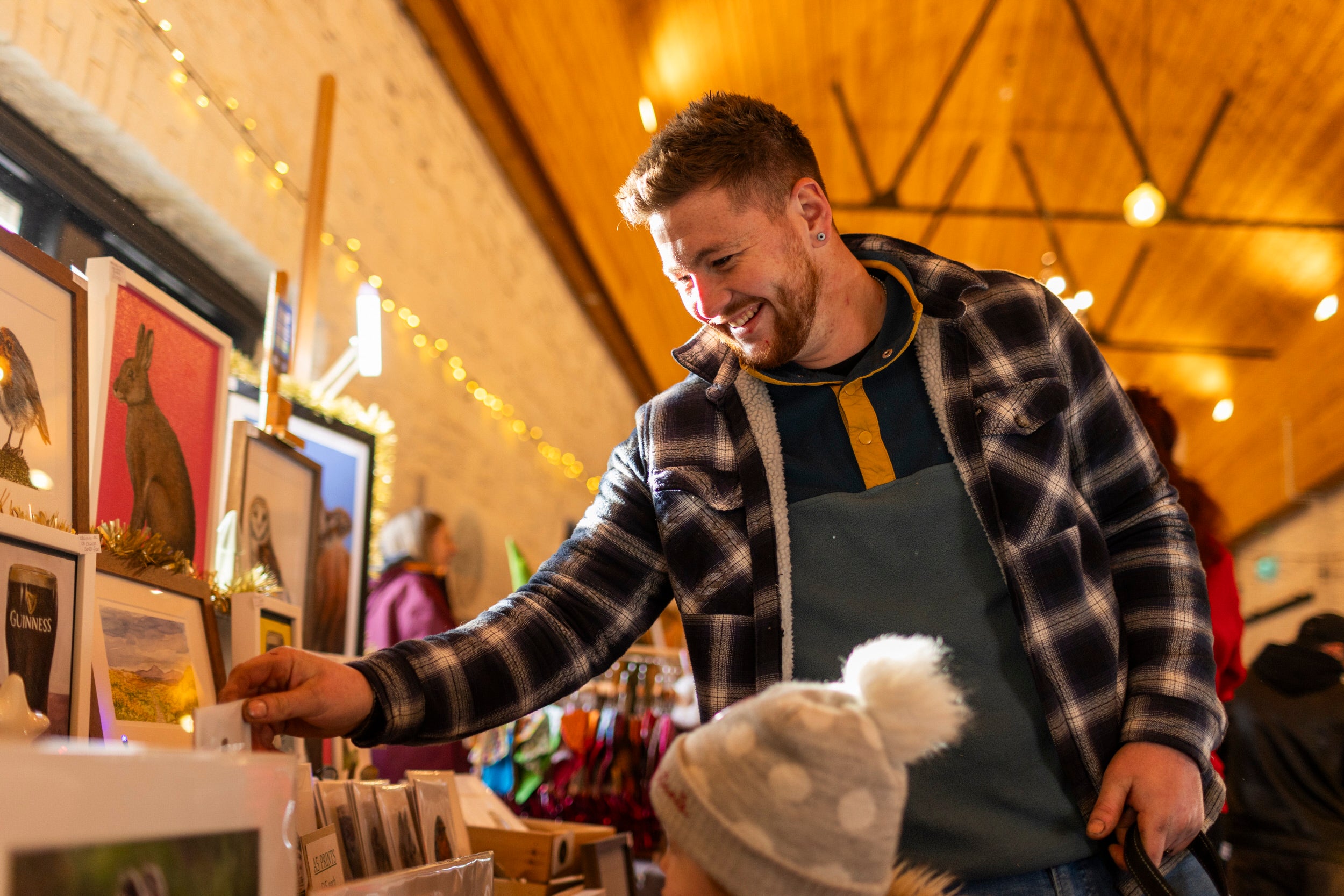 Man and daughter browse christmas market at Castle Ward