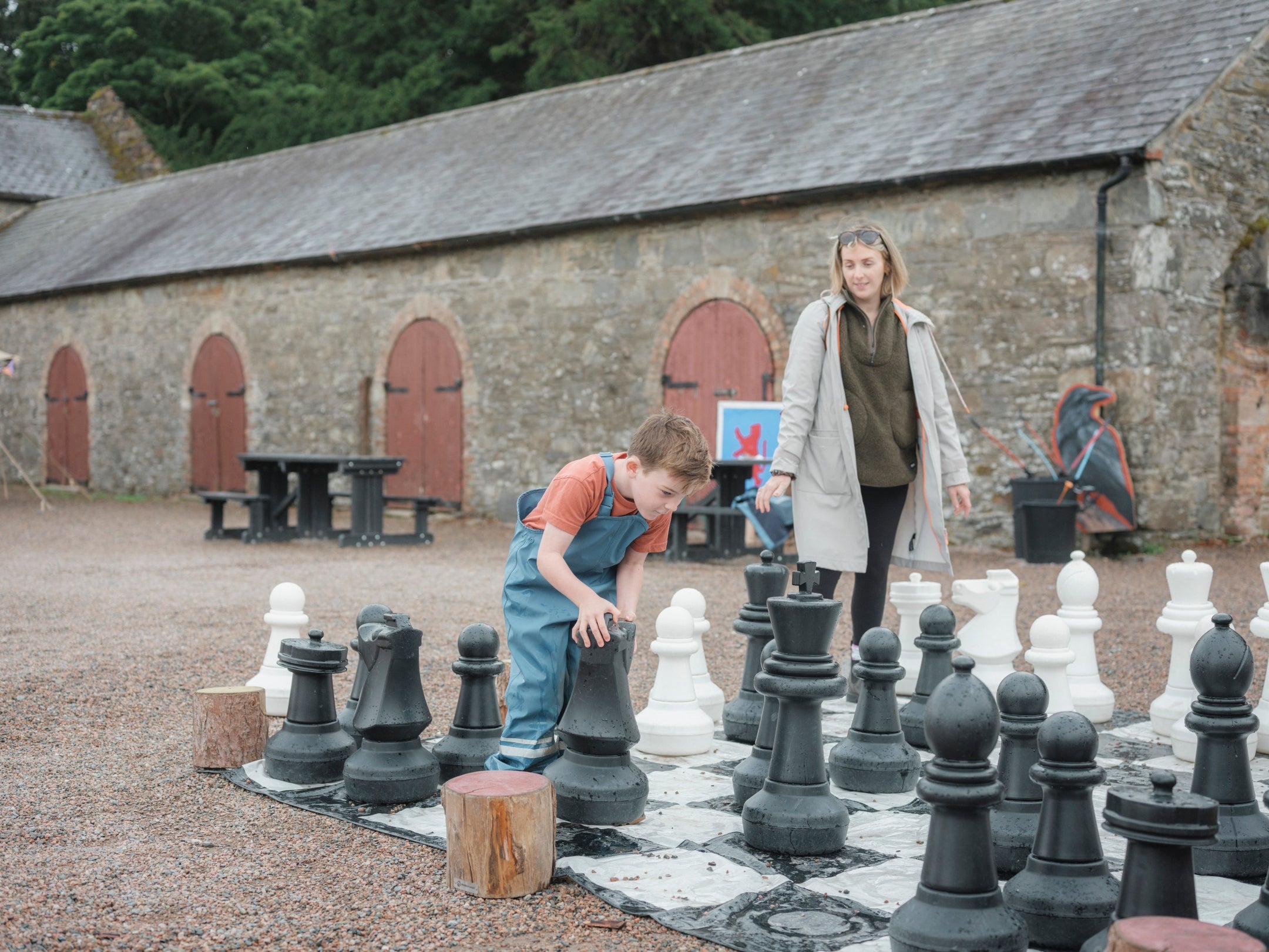 Family playing giant chess in summer
