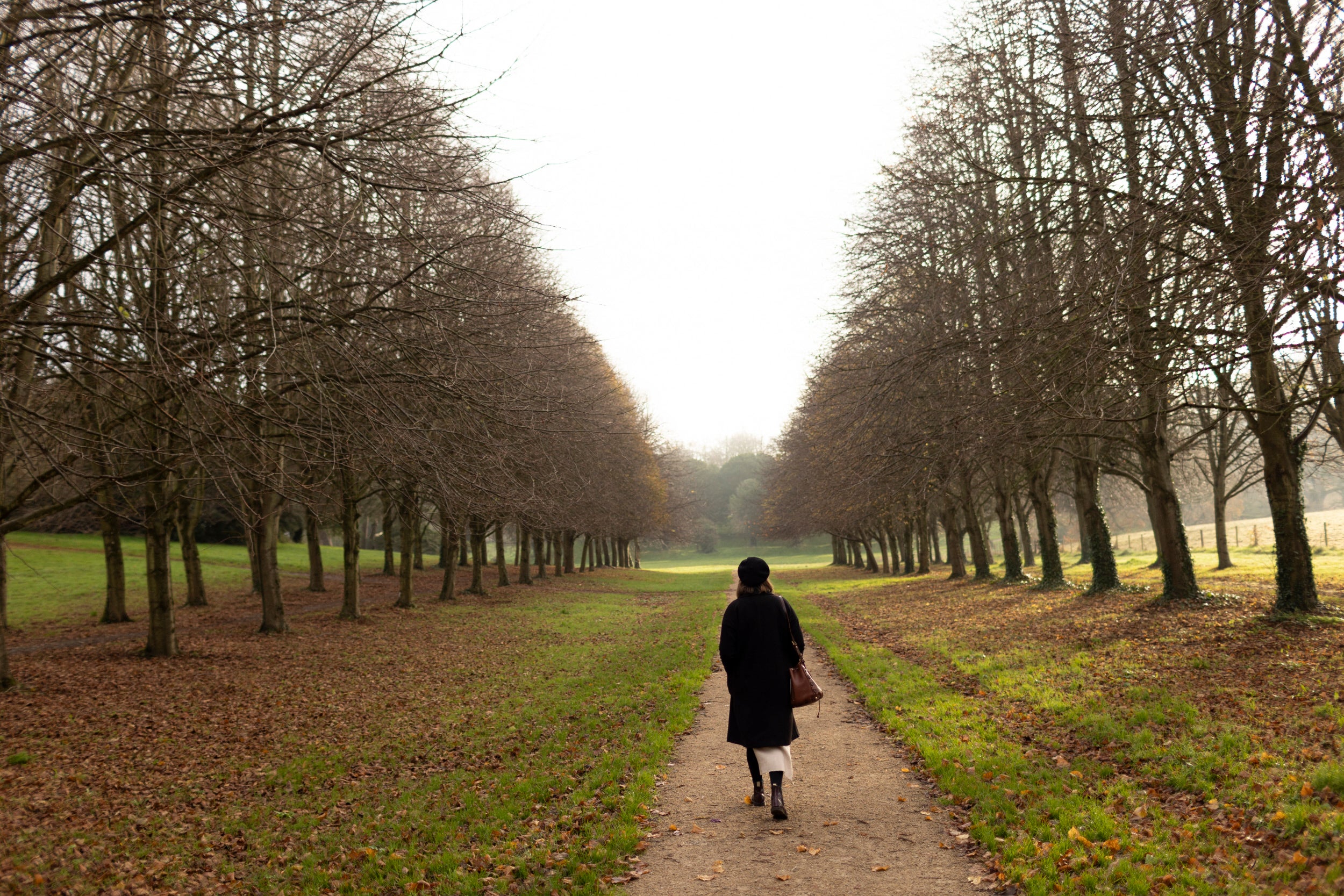 A woman walking down Lime Tree Walk at Castle Ward