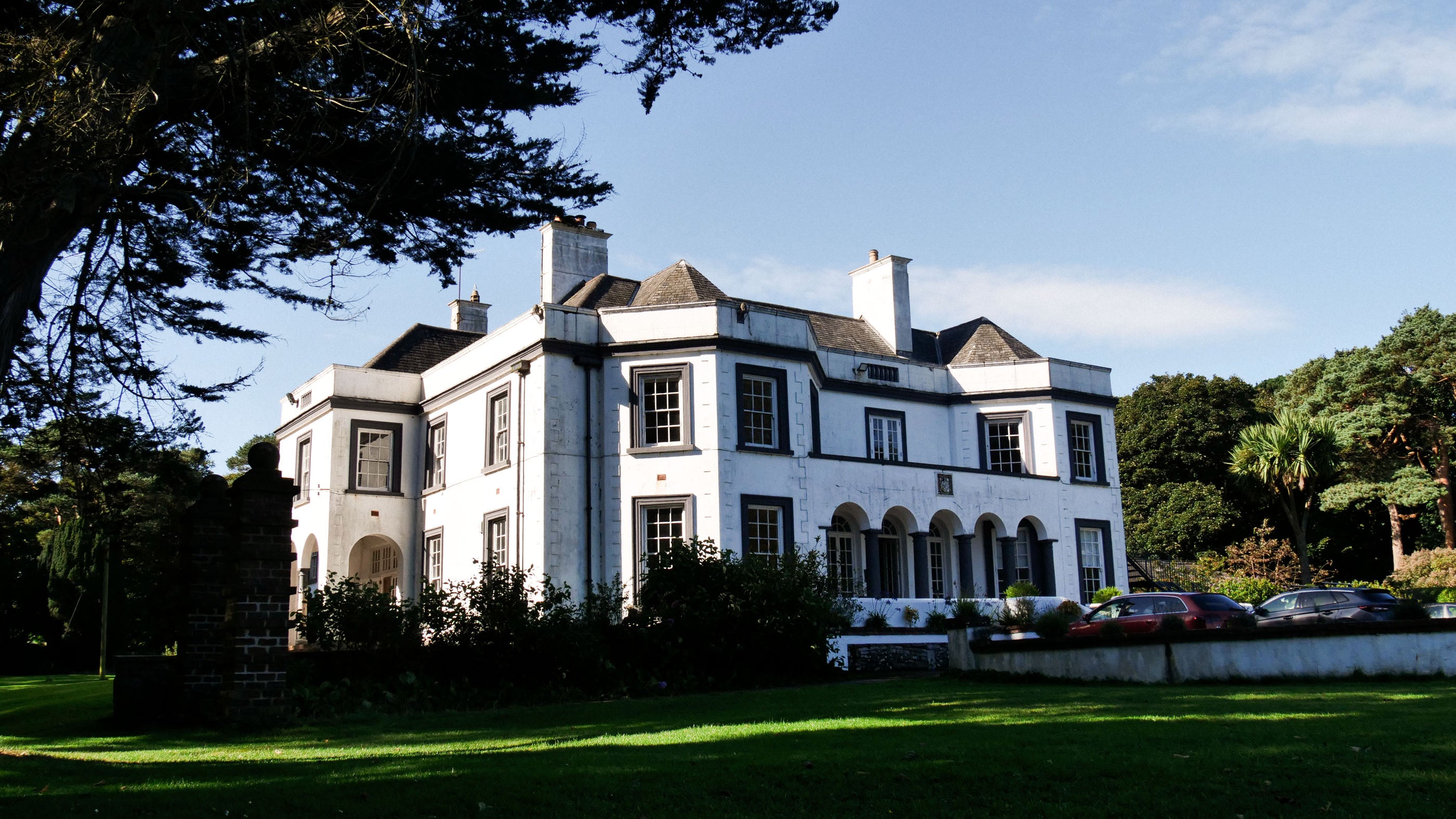 A photograph which features Cushendun's Glenmona House.