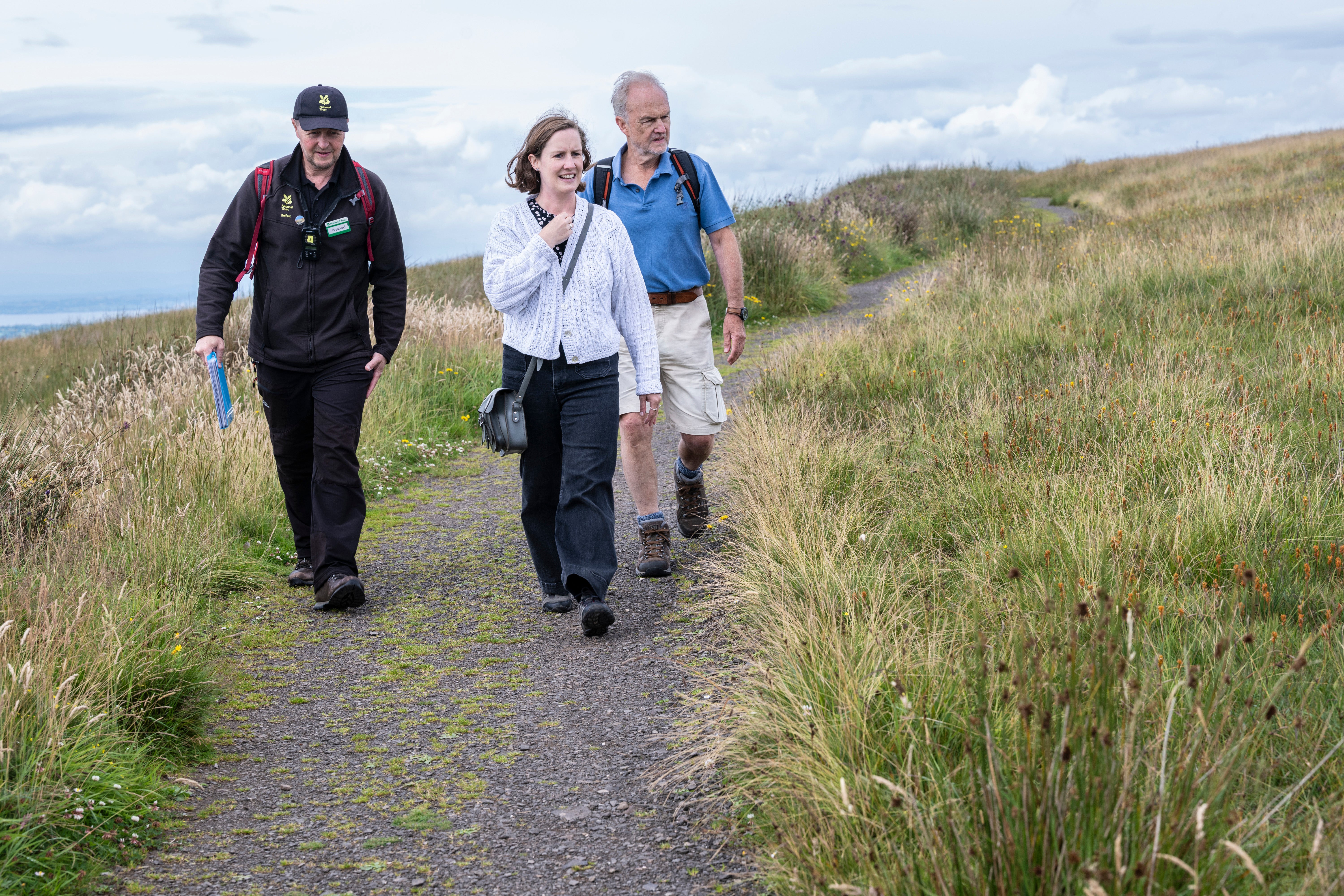 Welcome Assistant taking visitors on a guided walk on Divis Moutnain
