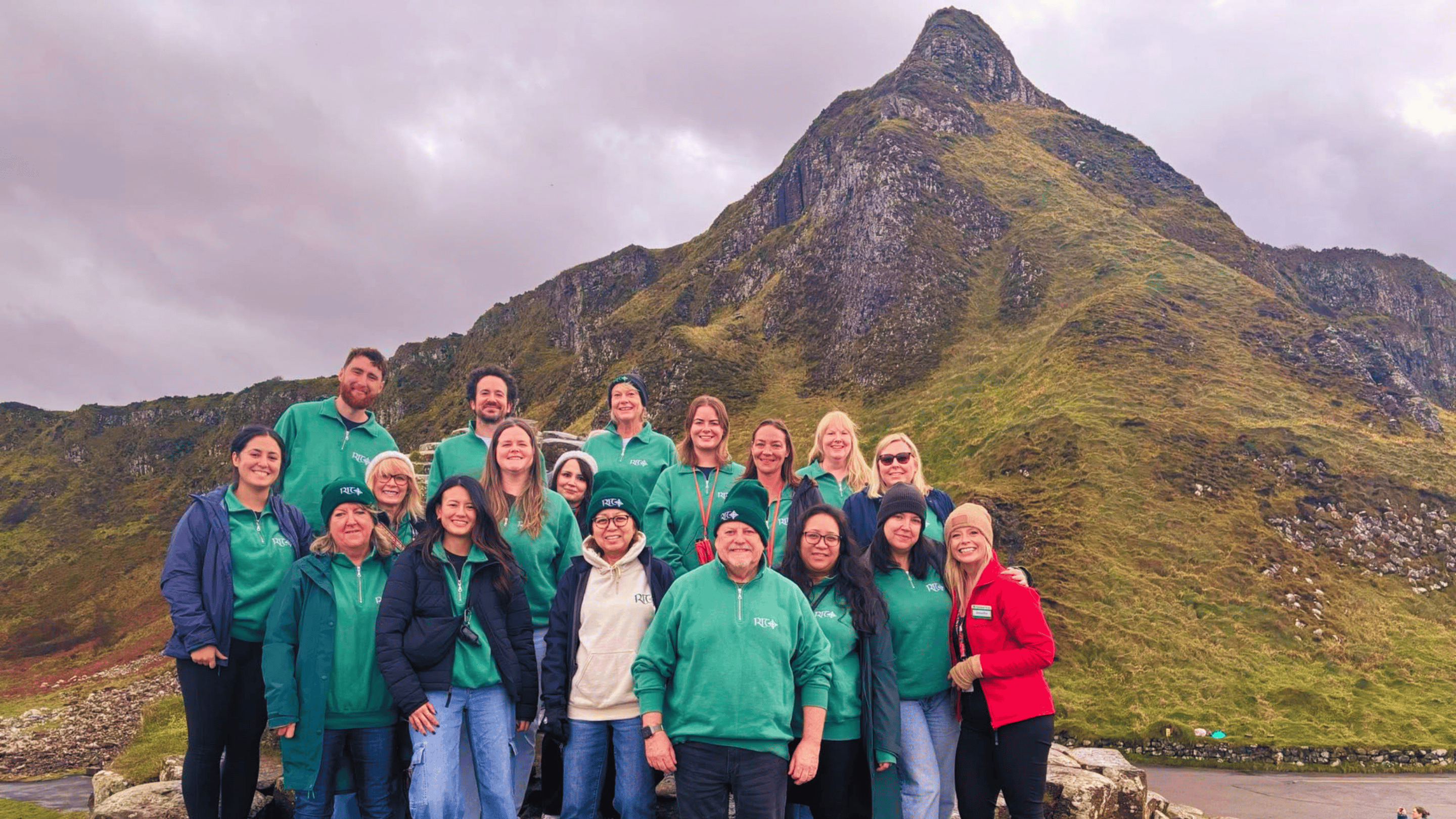 A group of approximately 17 people from RIT Travel thoroughly enjoying their visit to the Giant's Causeway