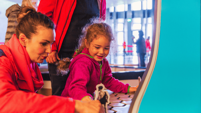 A family enjoying the interactive activities within the exhibition and interpretation area of the Giant's Causeway Visitor Centre