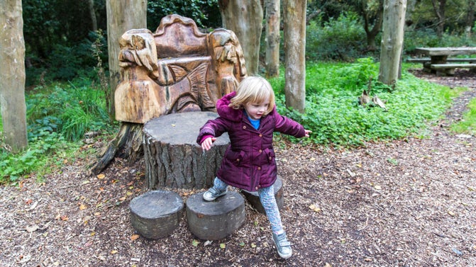 Girl in the natural play area at Mount Stewart, County Down