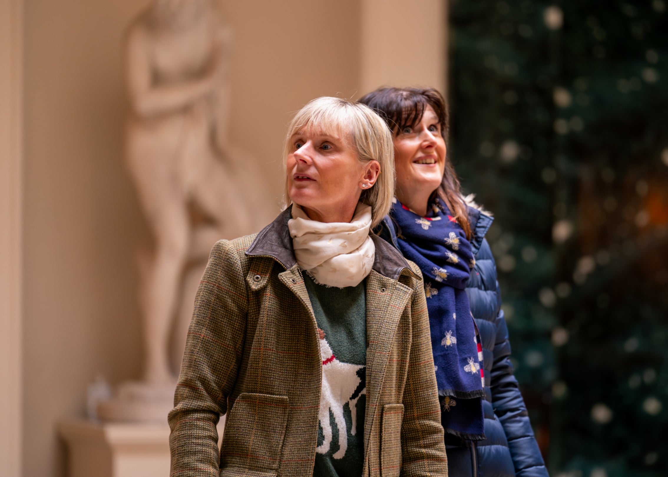 Two women walking in the Central Hall of the House