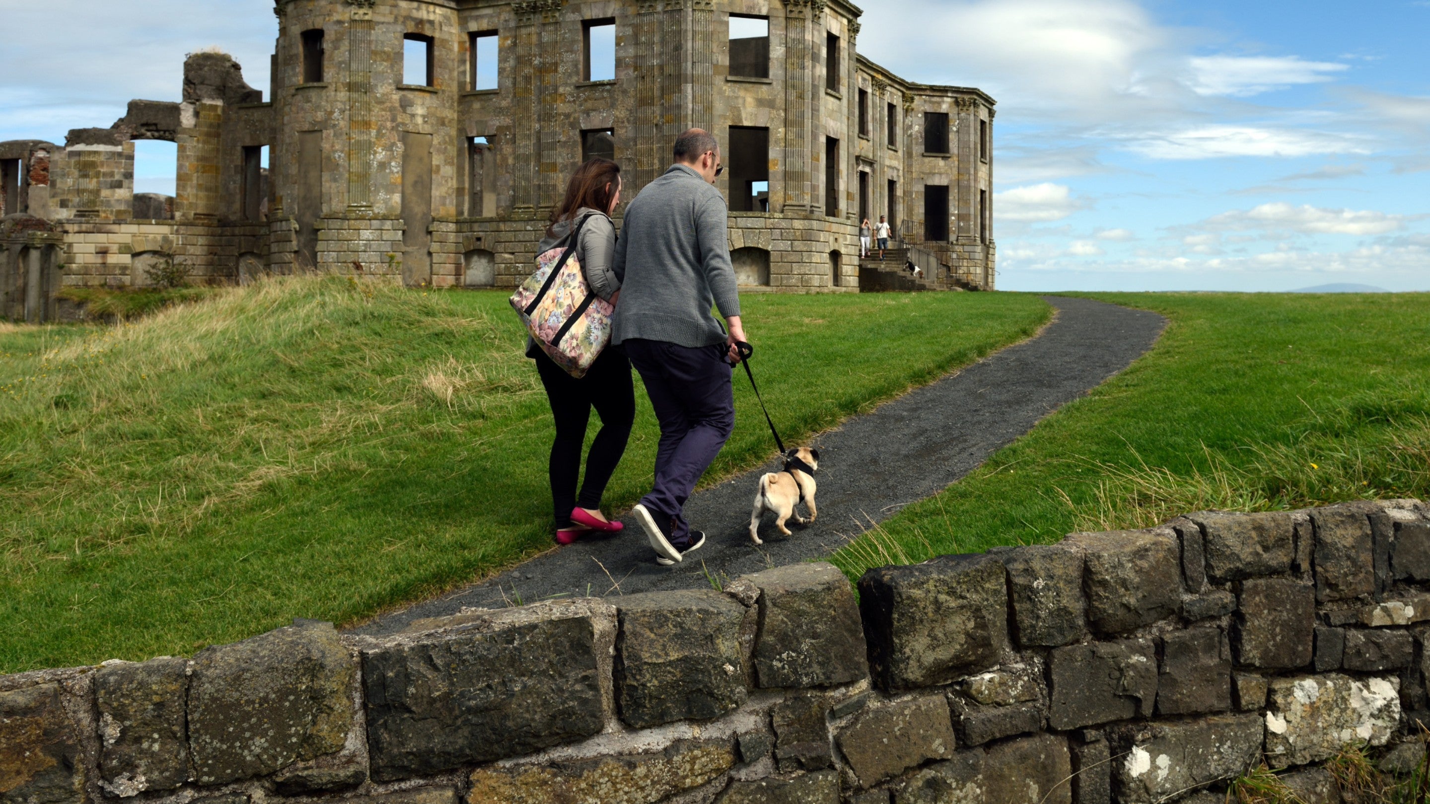 Visitors walking their dog at Mussenden Temple and Downhill Demesne , County Londonderry