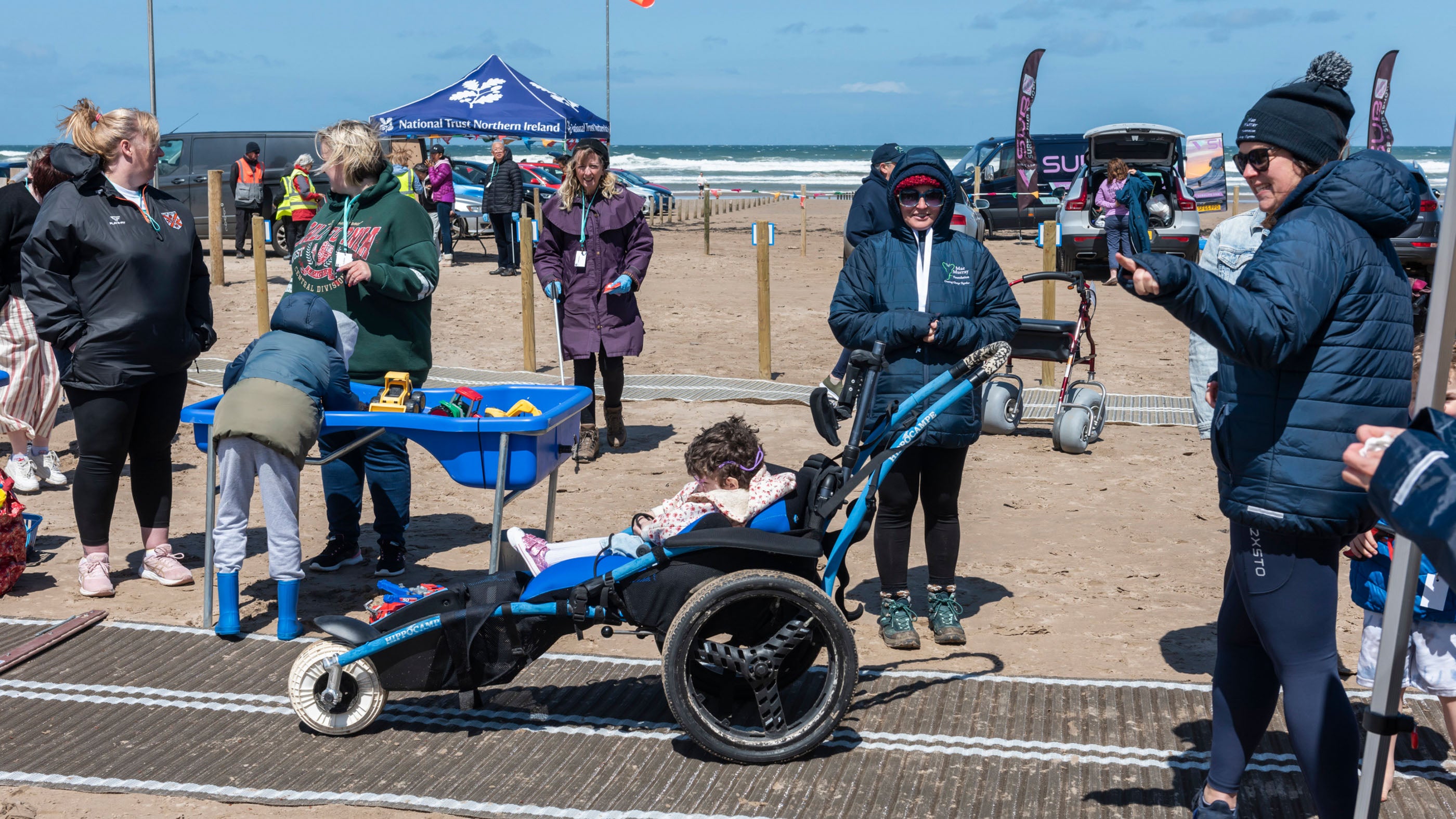 A photograph of visitors enjoying the Big Help Out 2024 event in partnership with Mae Murray Foundation on the beach at Portstewart Strand.