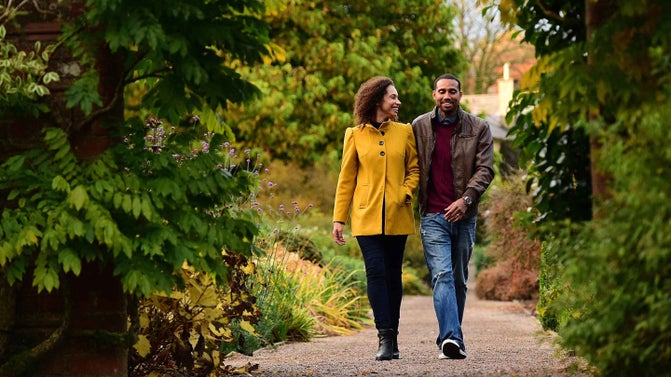 Couple walking in Rowallane Garden County Down in November