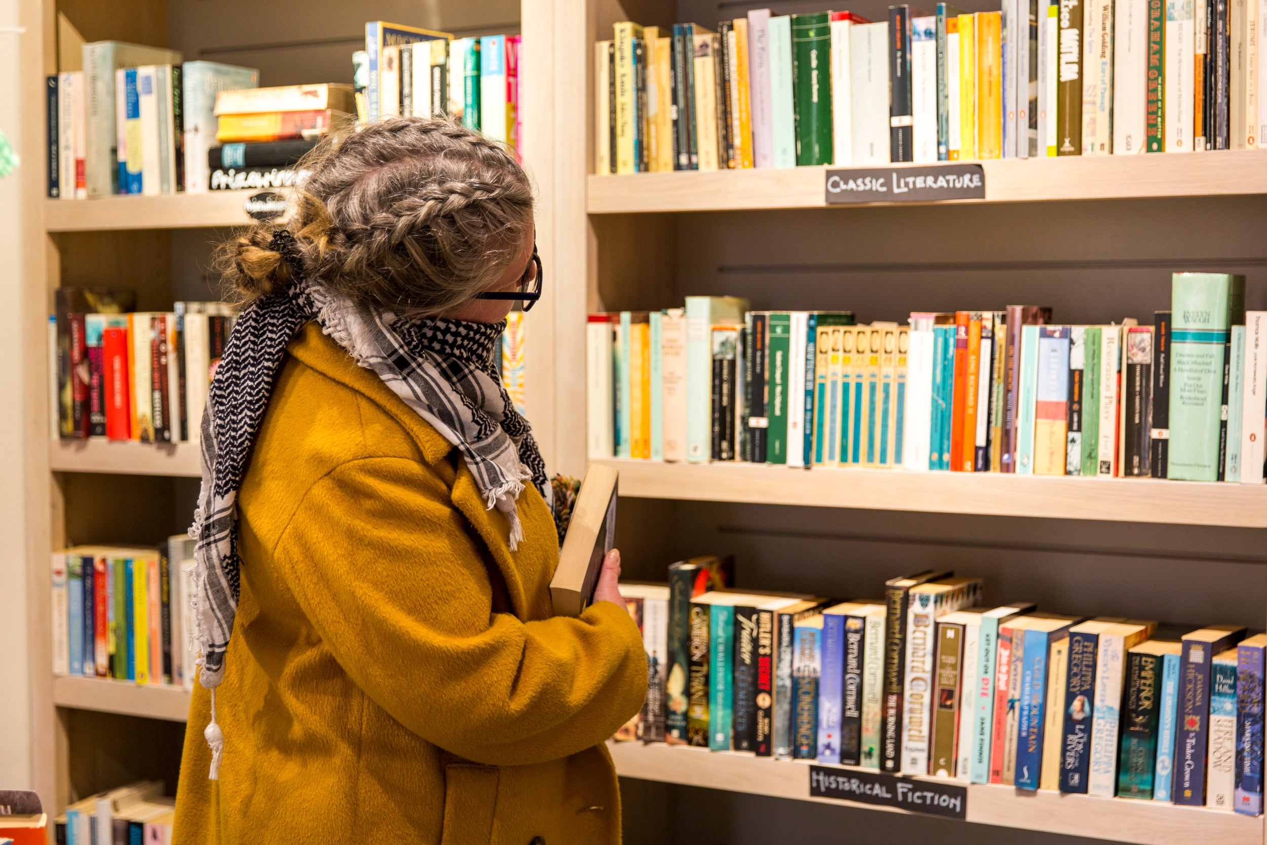Visitor browsing the shelves of a secondhand bookshop