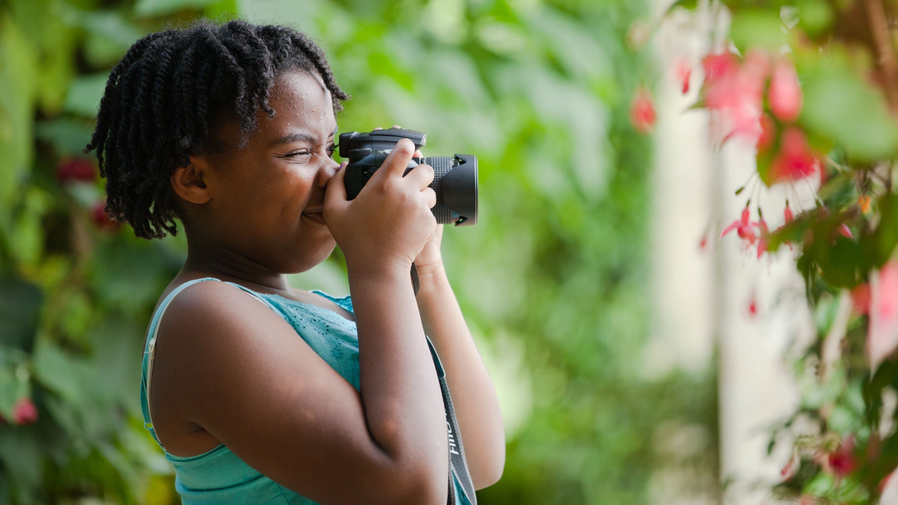 Child taking a photograph in the garden at Belton House, Lincolnshire