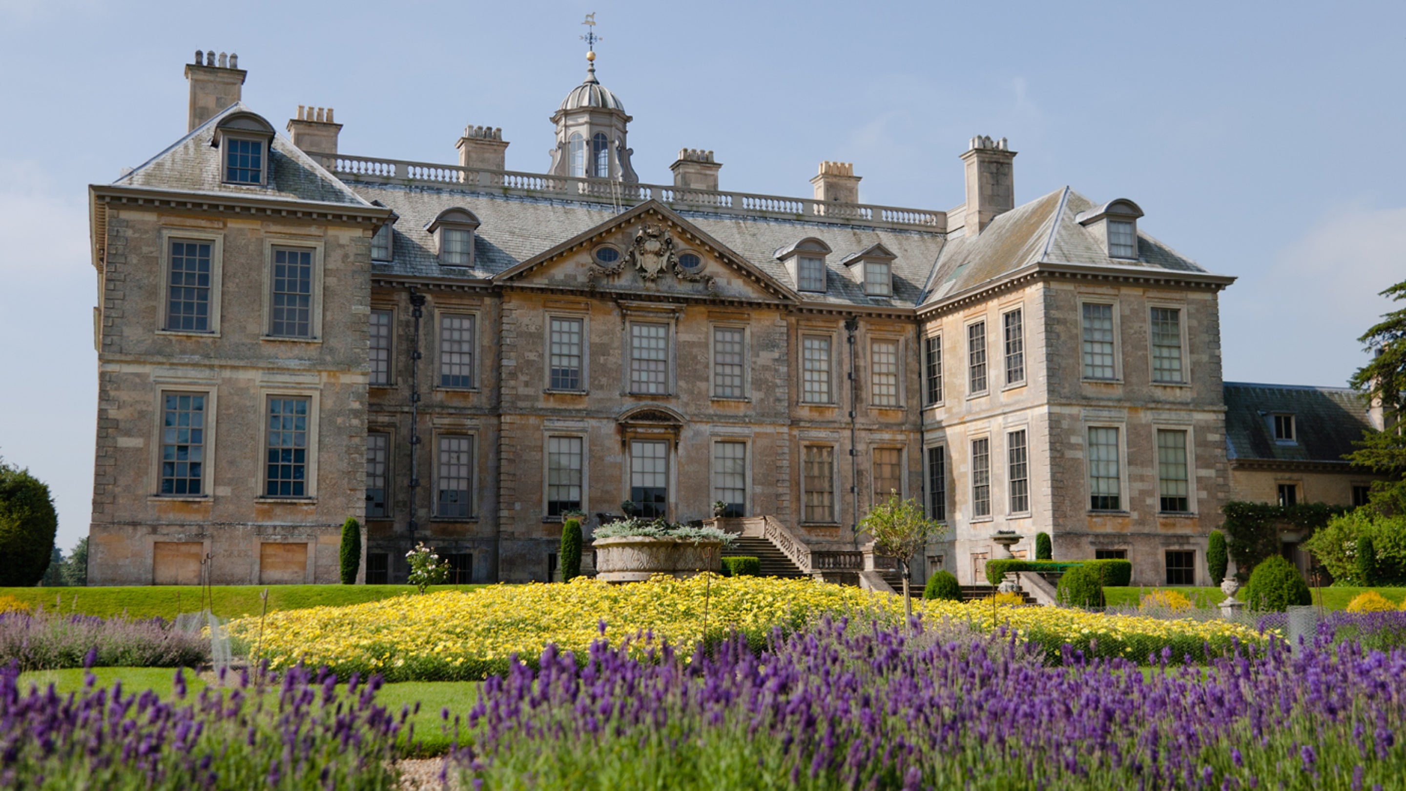 North front of Belton House with lavender blooming in the Dutch Gardens