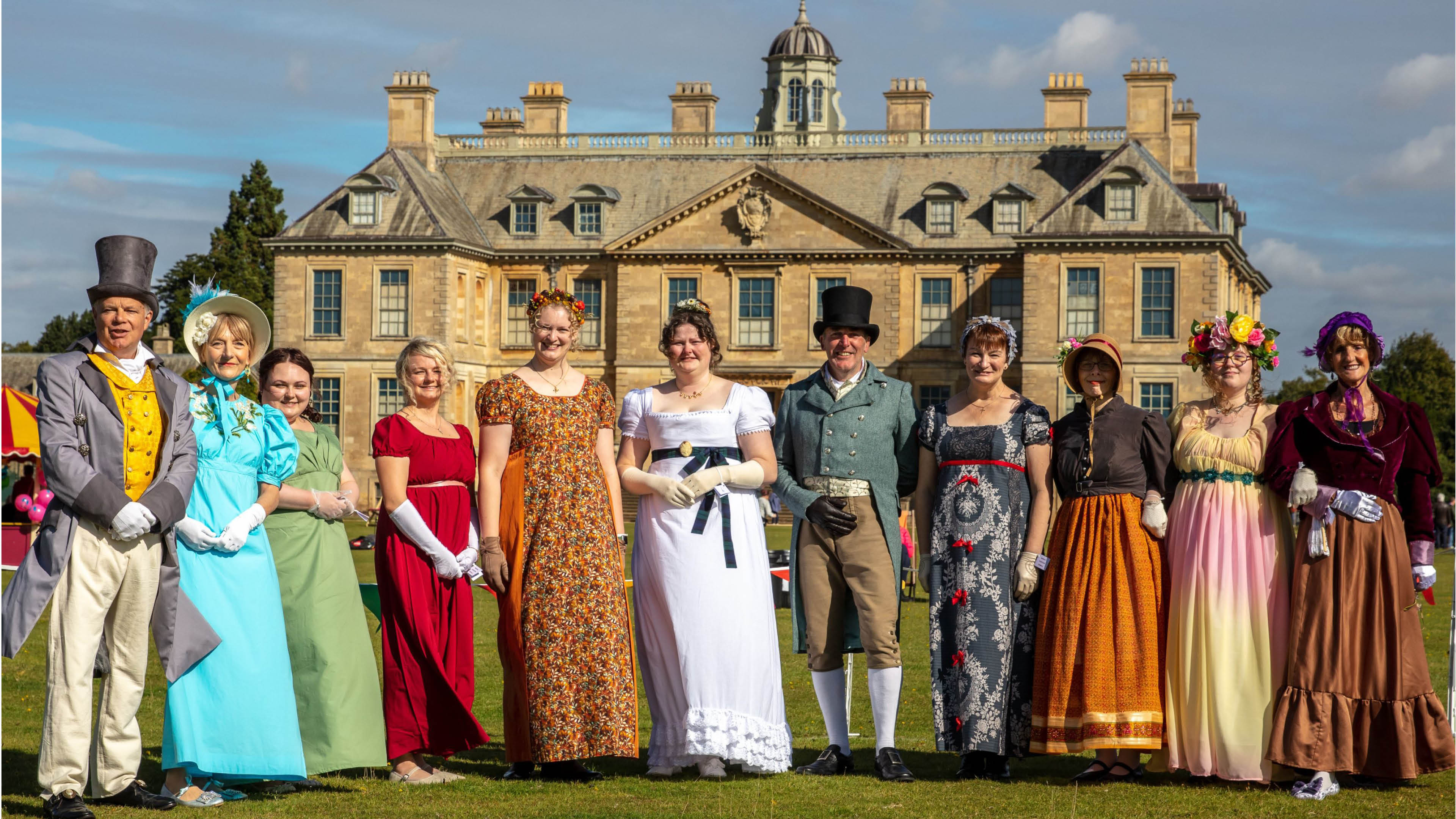 Costumed members of Bonnets and Breeches Dance Society gather outside Belton House