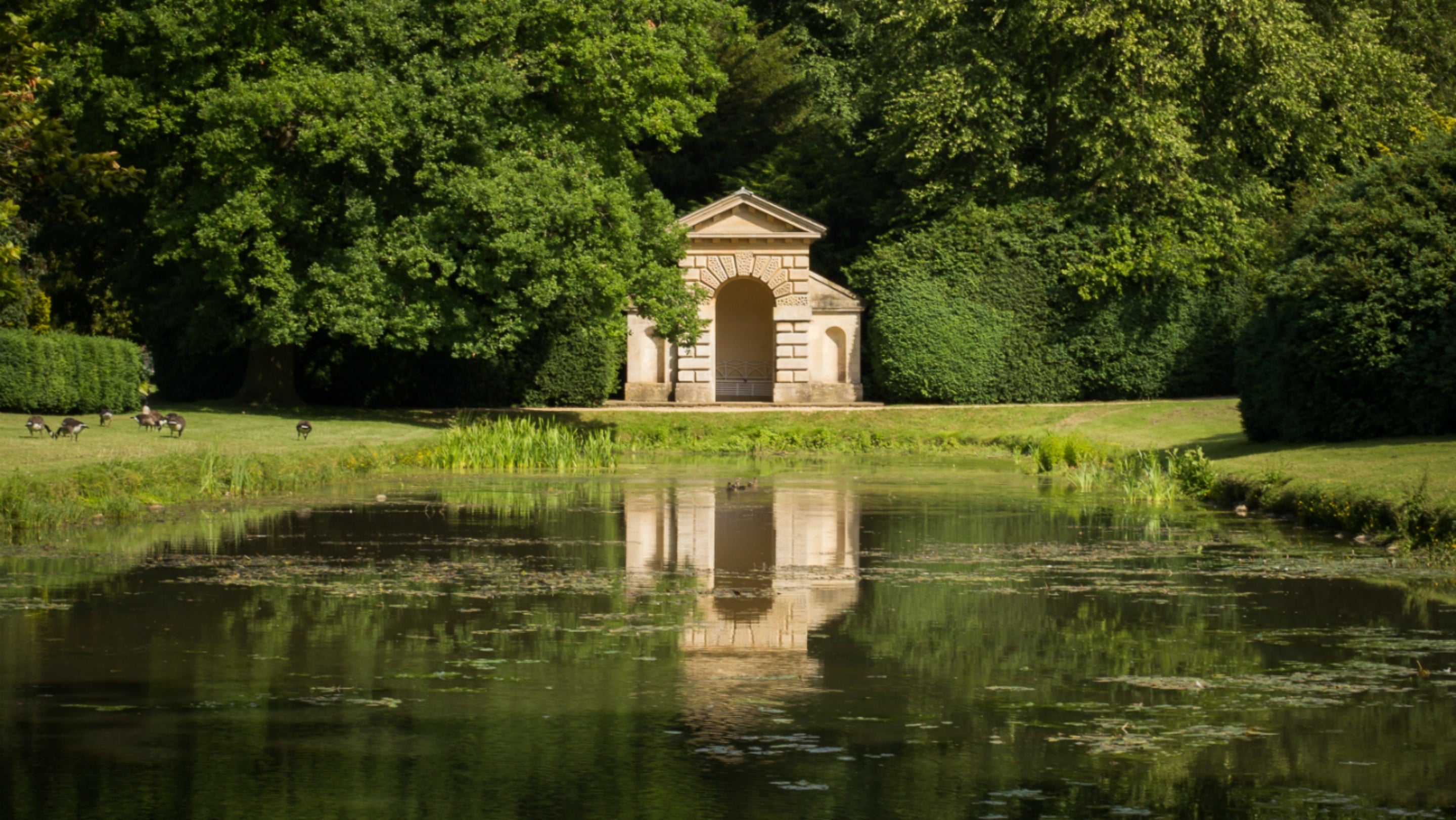 The Mirror Pond during the summer at Belton with the Garden Temple overlooking the pond