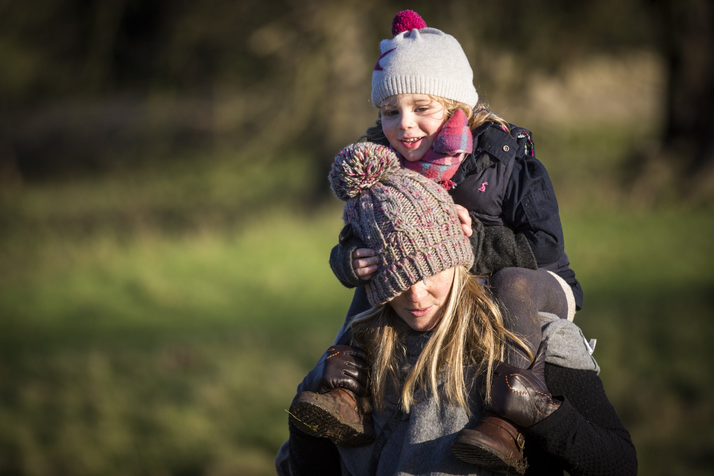Woman giving child a piggyback