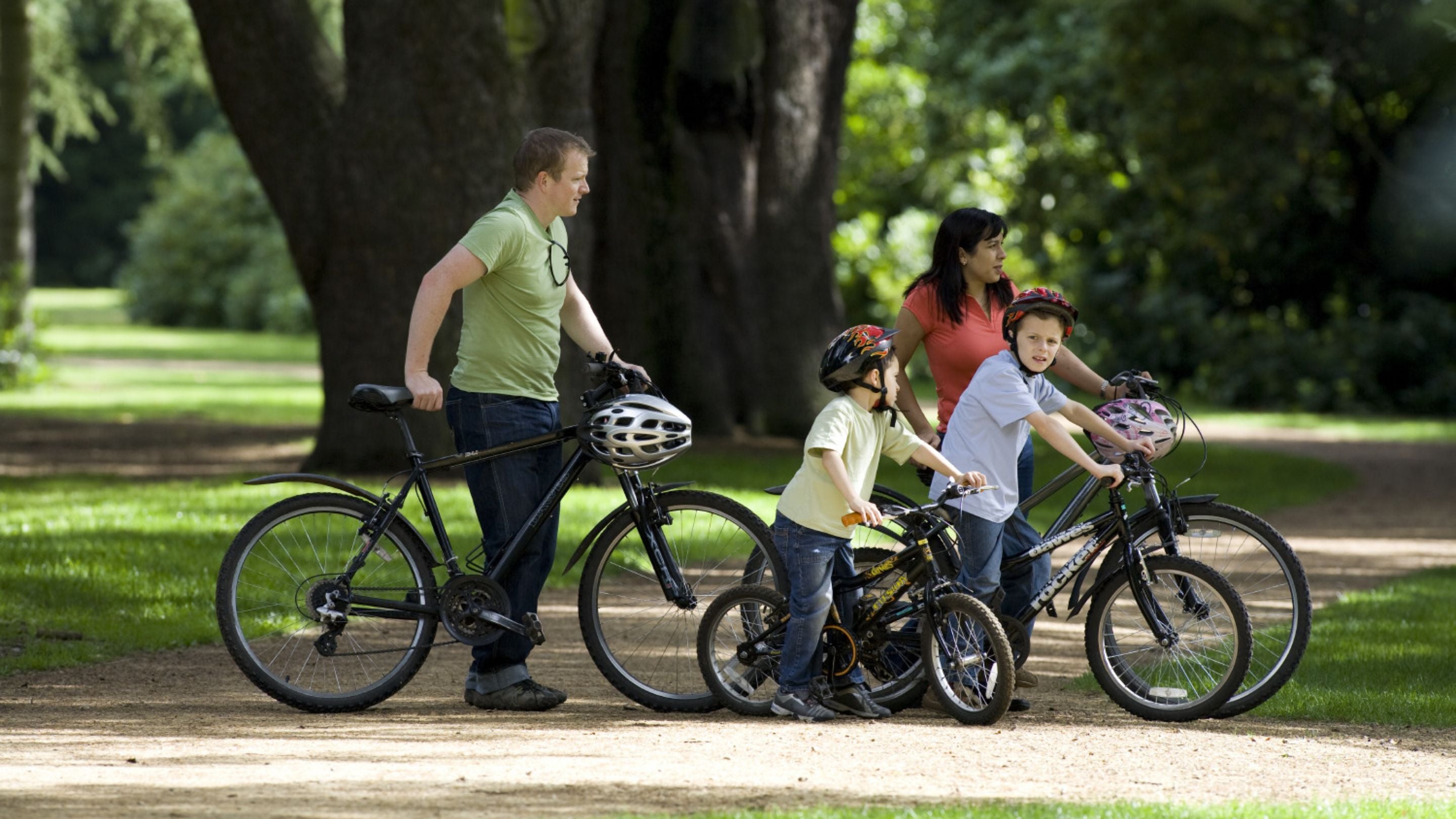 Family on bikes enjoying the gardens at Clumber Park, Nottinghamshire. Bicycles can be hired at Clumber daily from April to September, and at weekends and holidays from October to March.