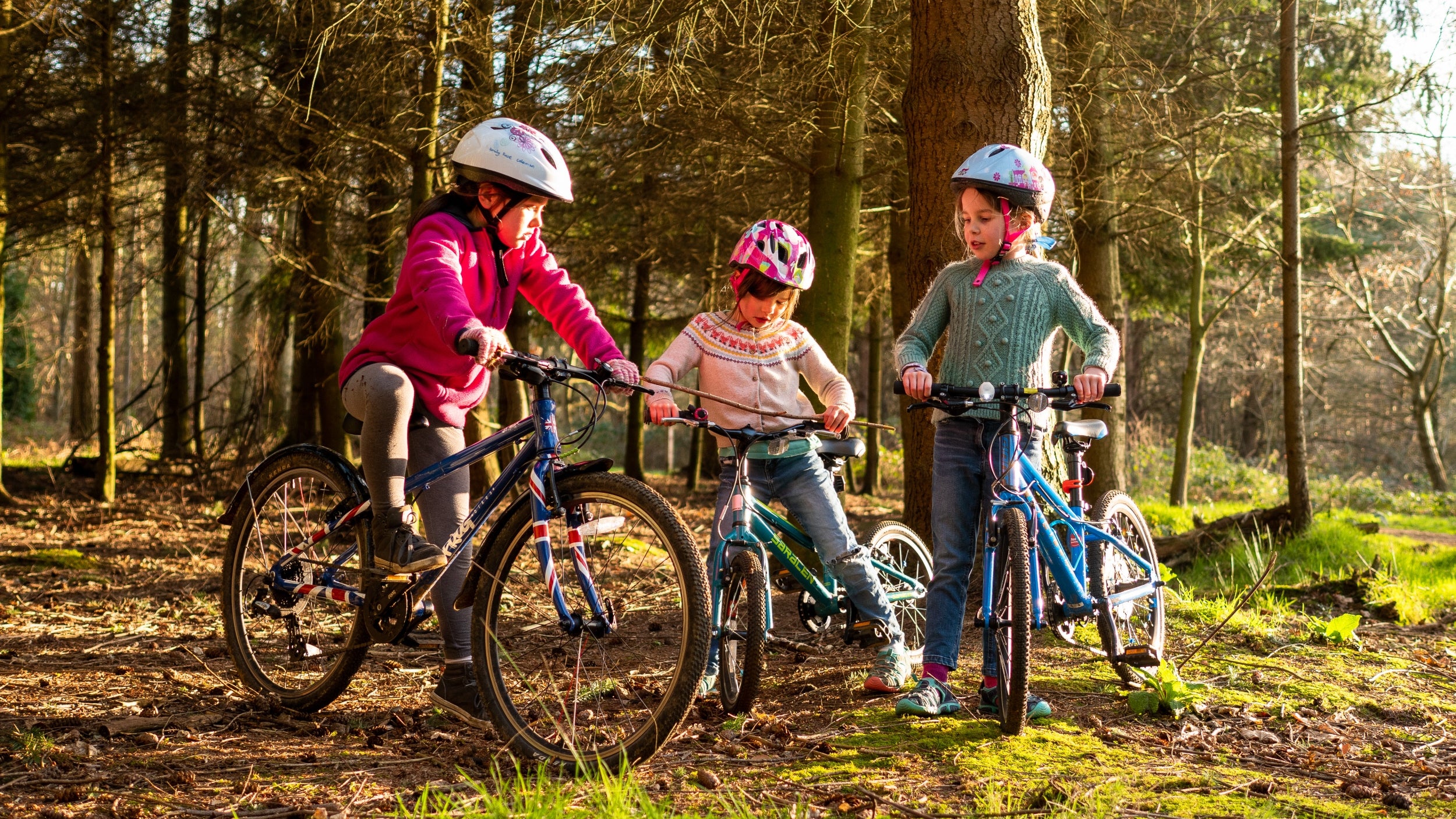 Children enjoying cycling in the woodland