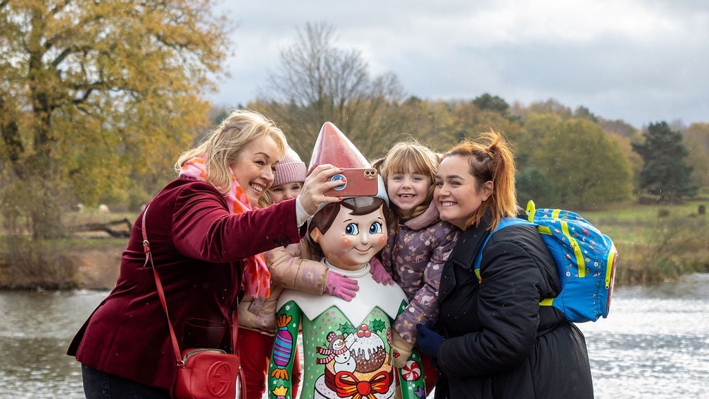 Visitors enjoying The Elf on the Shelf sculpture trail