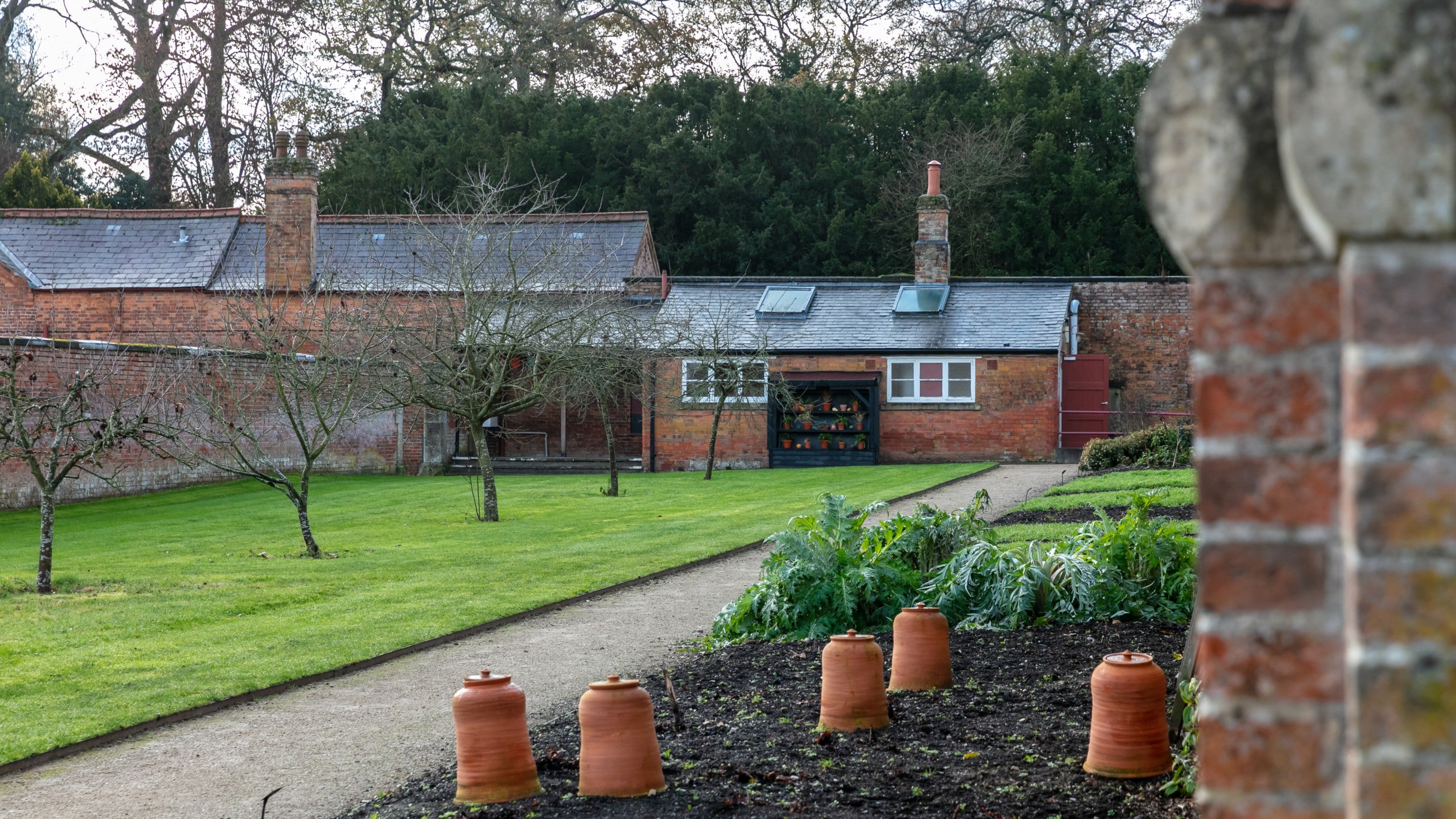 View across the garden borders and apples trees in the walled kitchen garden