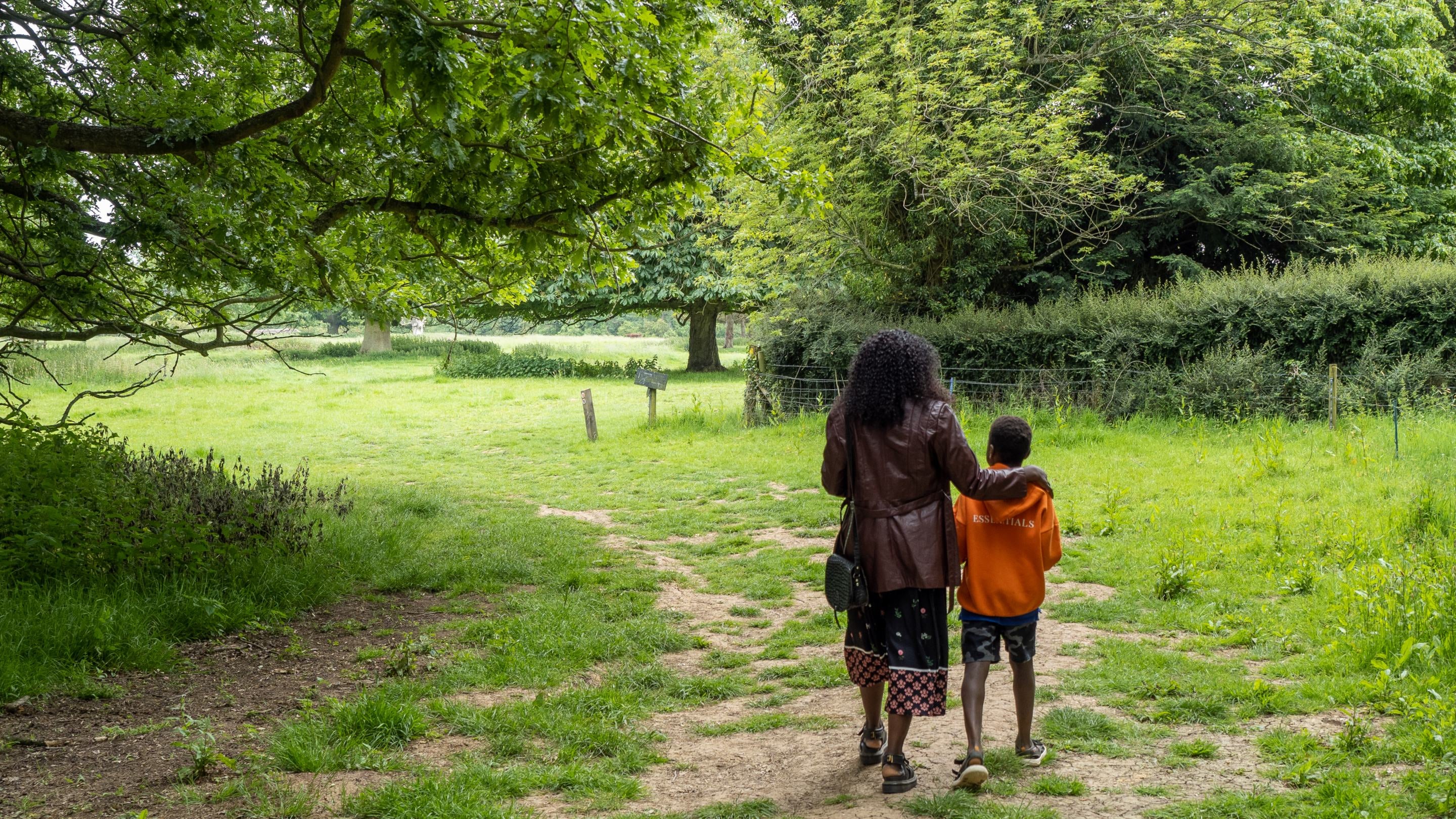 Family visitors walking at Gunby Estate, Lincolnshire in the summer.