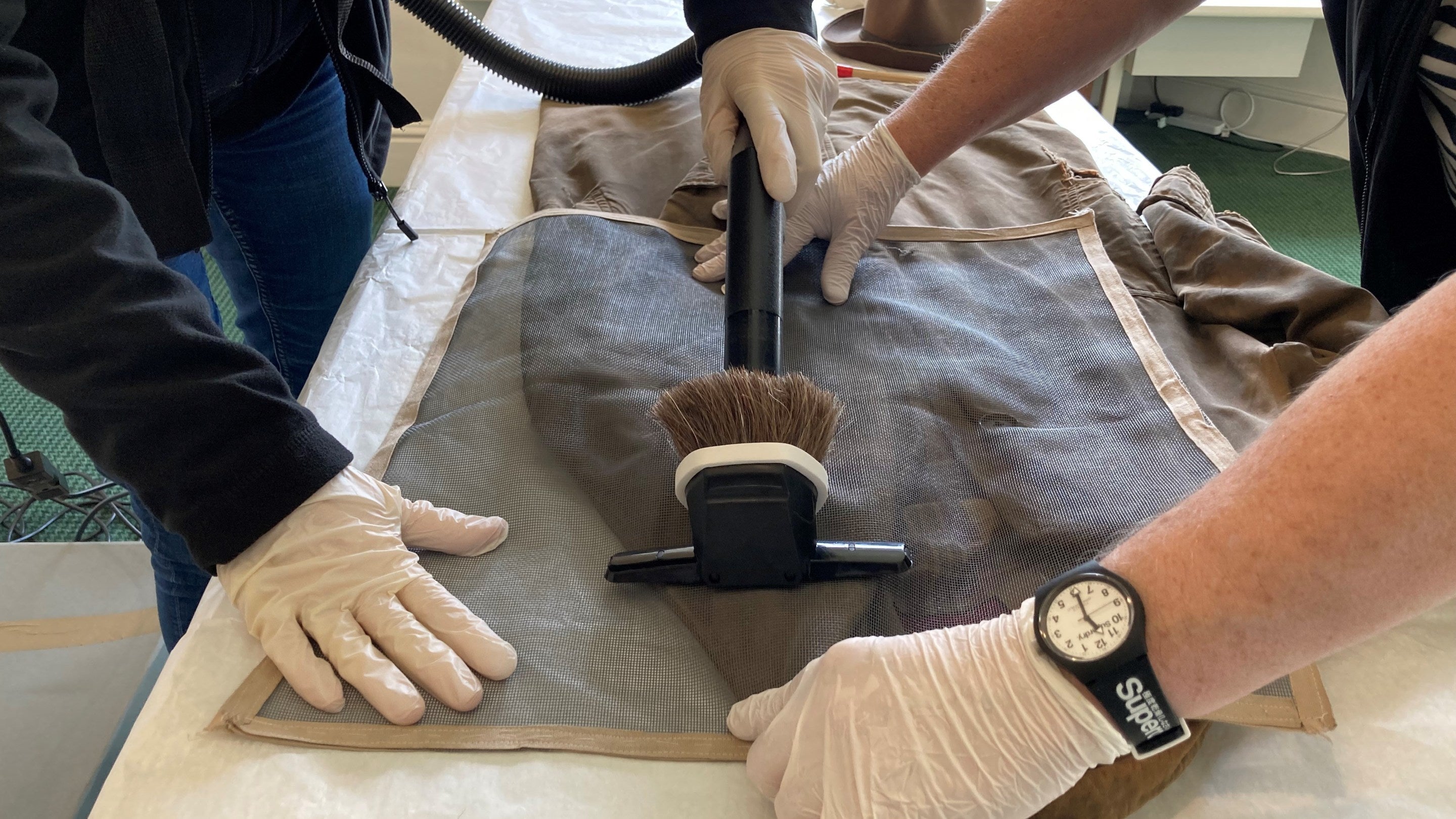 The team  gently clean William Straw Sr's coat