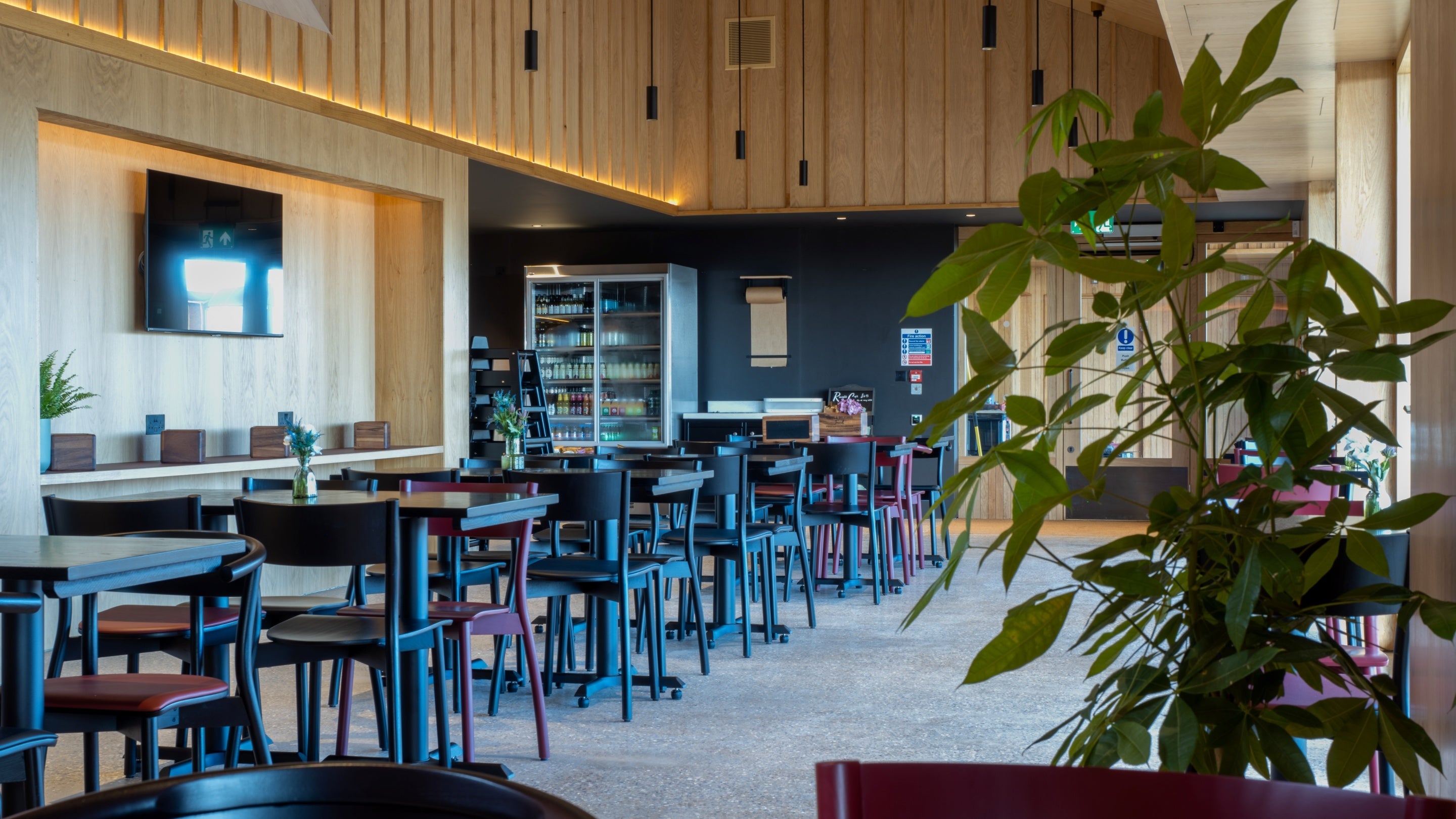 Inside the Flyway cafe showing rows of black tables.