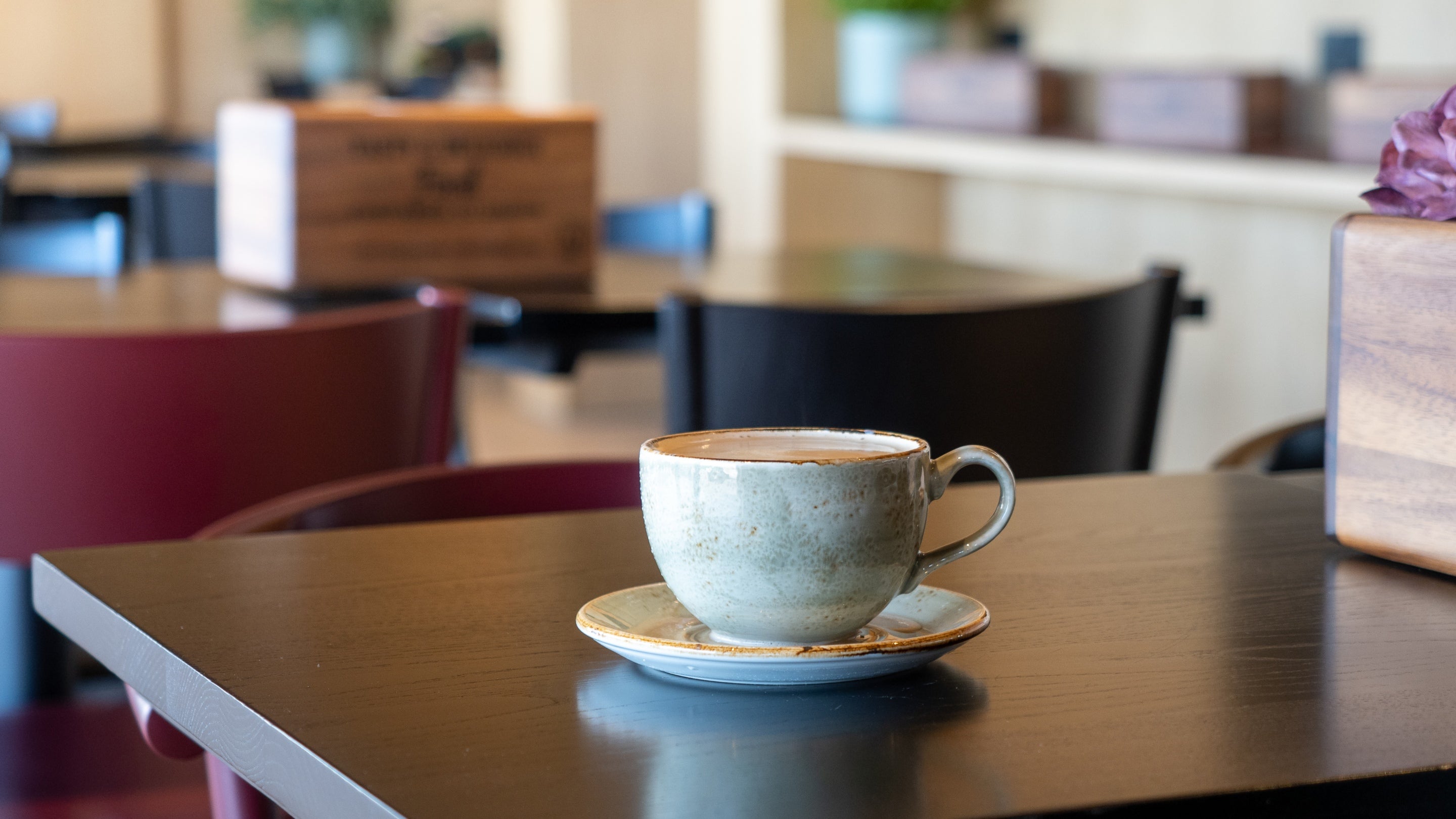 A coffee cup on a table inside the Flyway Café
