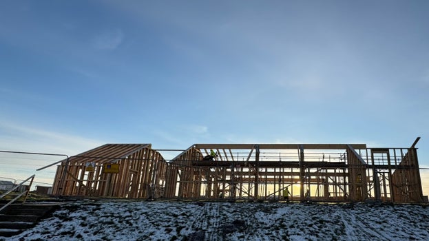Timber frame of the new café building under construction at Sandilands, with winter frost on the ground.