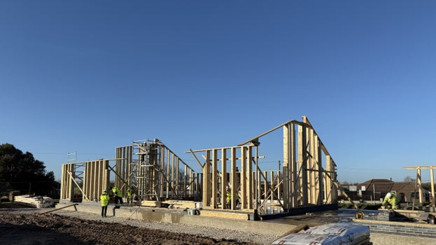 Timber frame structure of the new café building being assembled at Sandilands Nature Reserve by construction workers.