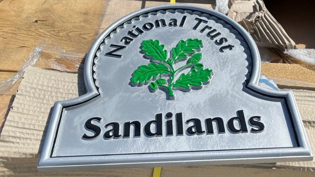 National Trust Sandilands sign with oak leaf emblem prepared for installation as part of the new visitor facilities.