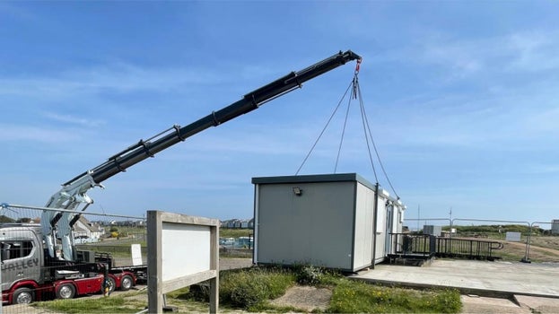 Crane lifting a portable cabin into place at Sandilands Nature Reserve to create a temporary site office.